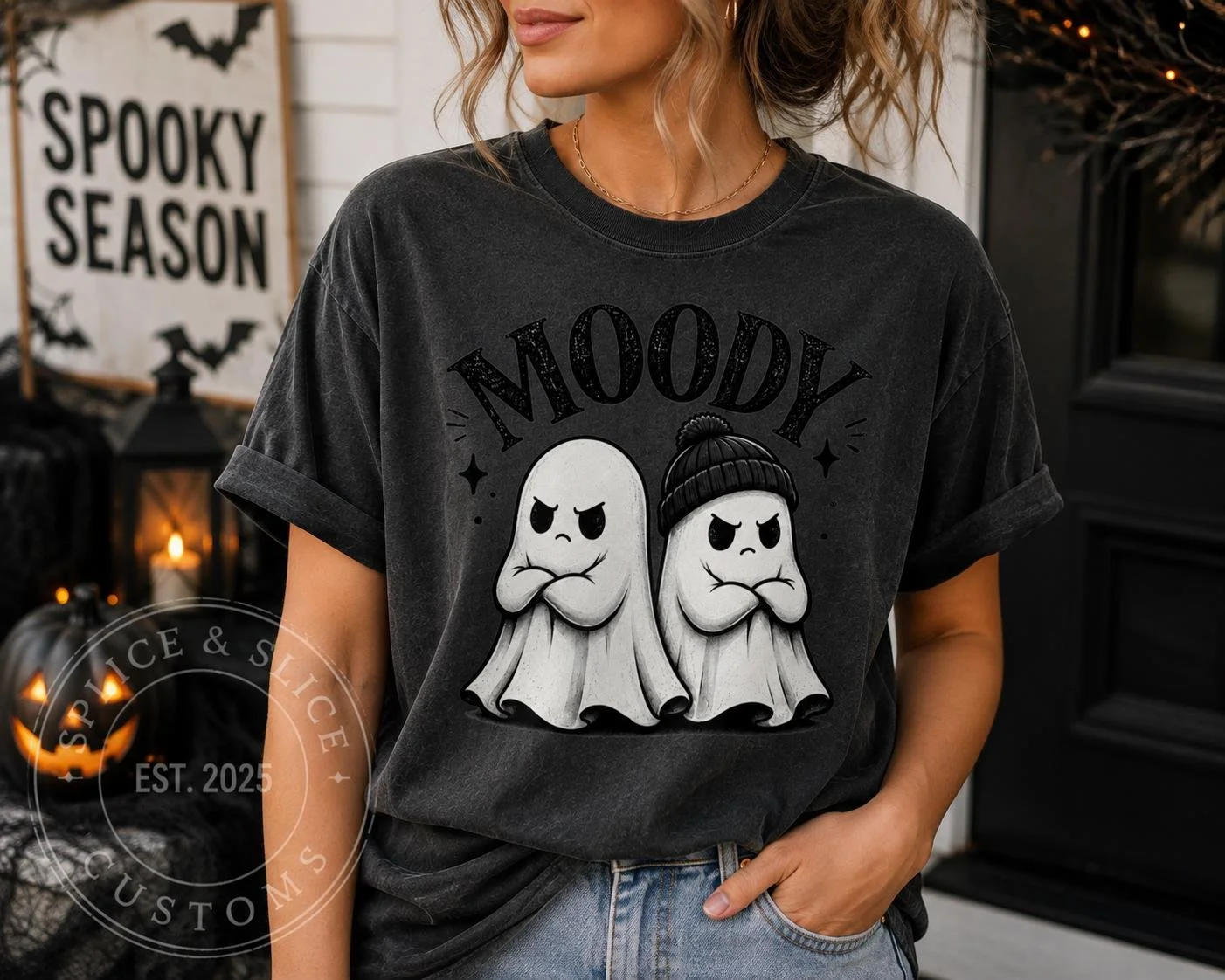 Charcoal gray t-shirt with a graphic of two grumpy ghosts, one wearing a beanie, above the text MOODY.