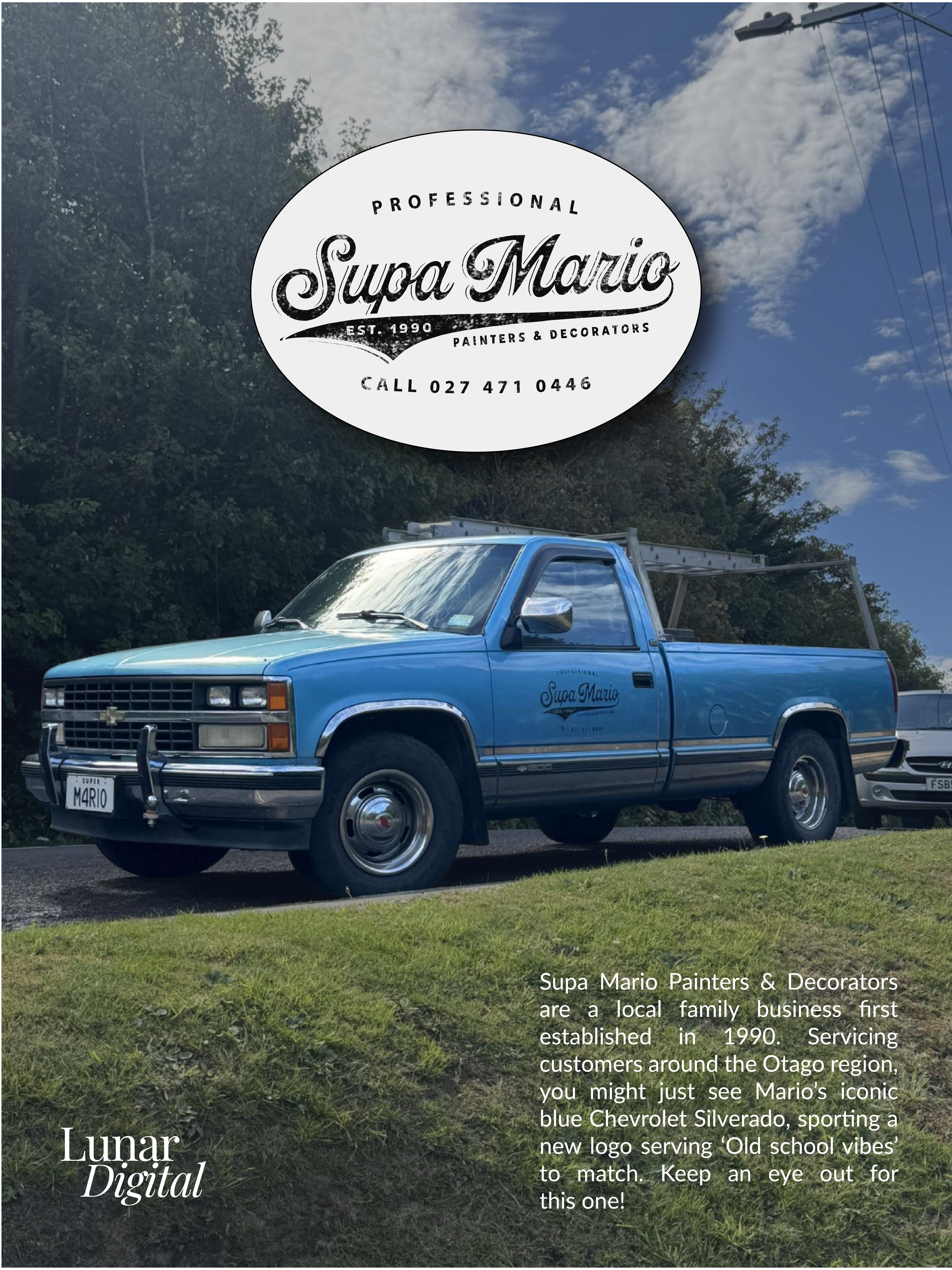 A vintage blue Chevrolet Silverado truck parked on grass with trees and a sky with clouds in the background. There is a large circular sign near the top with the logo and contact information for Supa Mario, a paint and decorate business established in 1990.