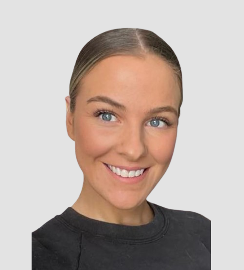 Young woman with blonde hair pulled back, smiling, wearing a black top against a gray background. Elise from JAYQ Plaster & Trades.