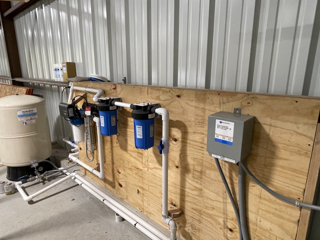 Rainwater filtration suite with UV sterilization and pressure tank for a residential system, installed by Reinewater Solutions in Fredericksburg, Texas.