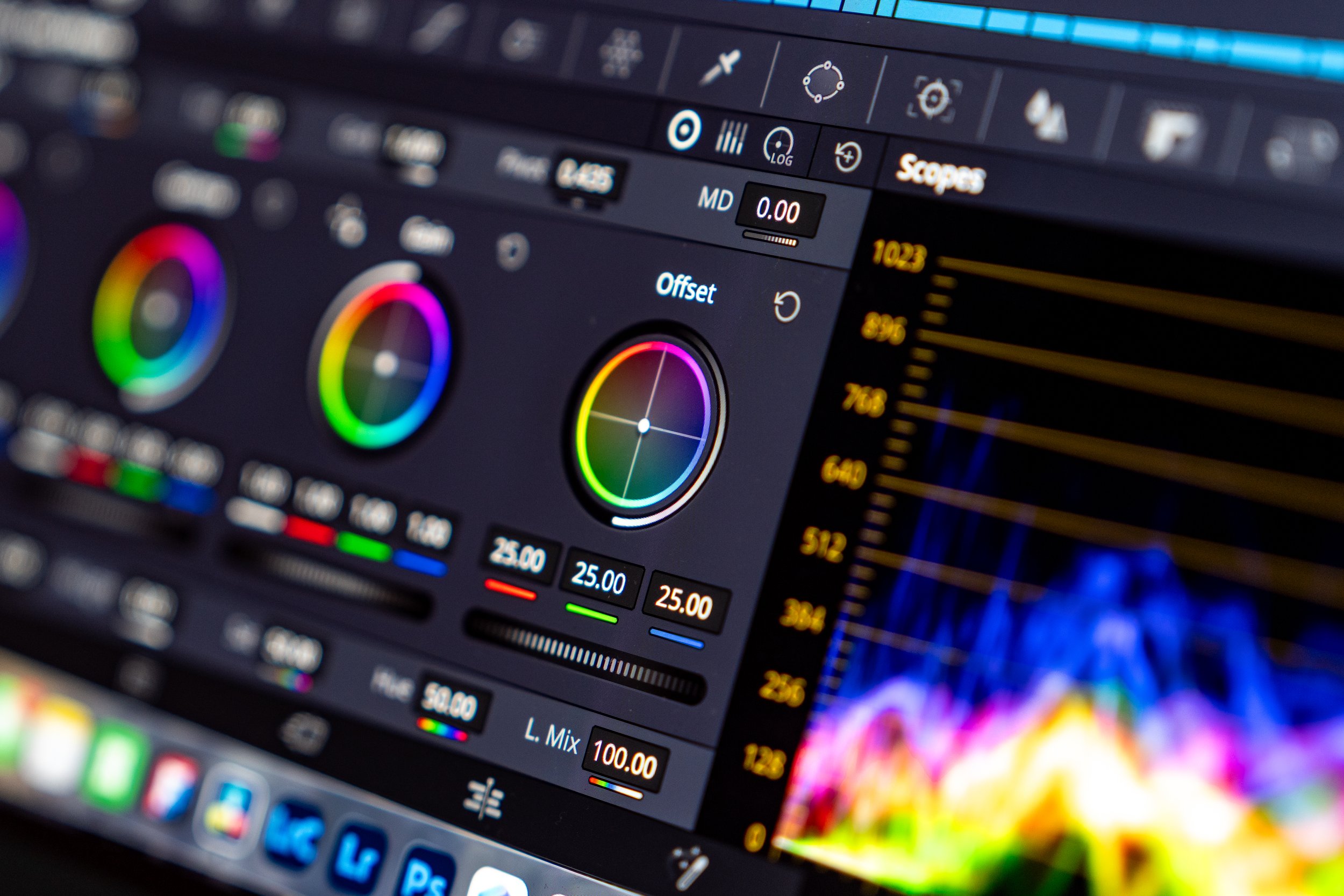 A digital audio editing software interface displaying color wheels for color correction, adjustment sliders, and a spectrum analyzer with colorful waveforms on a computer screen.
