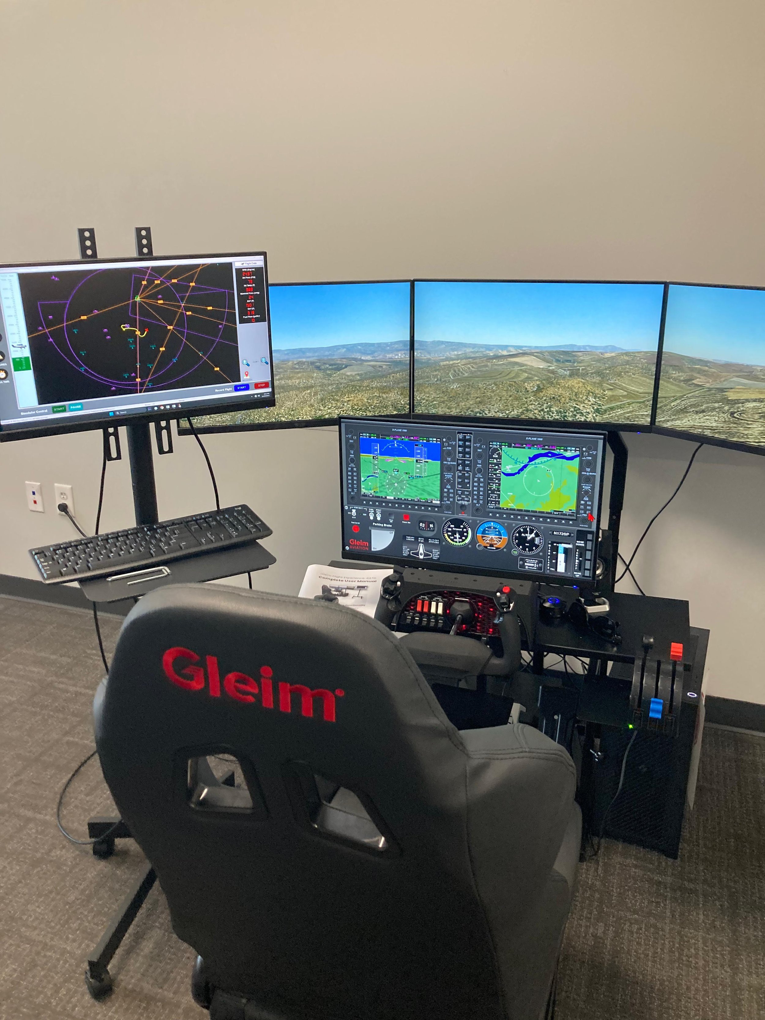 Flight simulator cockpit with three large monitors displaying terrain and navigation data, a Gleim-branded chair, and various flight controls and instruments.