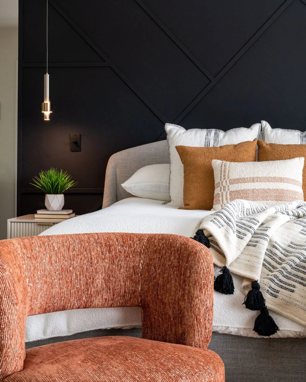 modern bedroom design with custome geometric dark accent wall and layered textiles in San Diego home