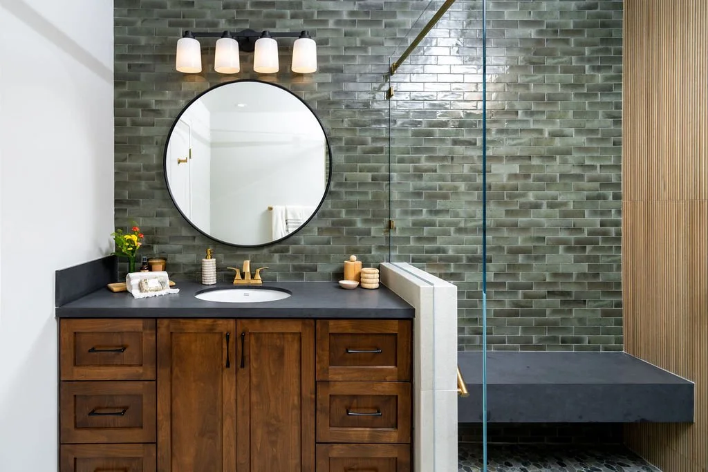 bathroom remodel with dark tile, custom wood vanity, and walk-in shower in San Diego home