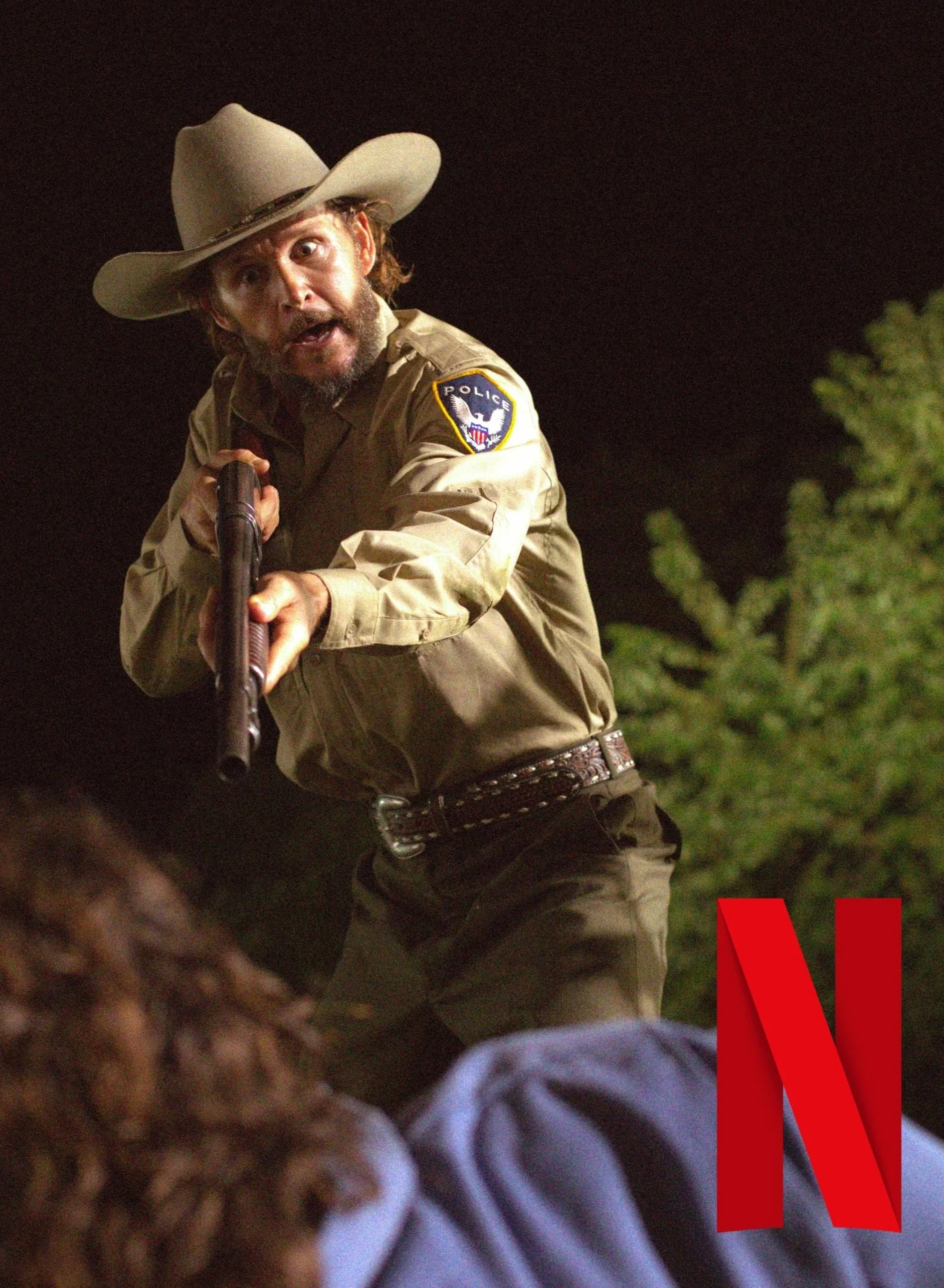 Ryan Kwanten in Head Count on Netflix & Starz & Shoutfactory.  Neo Western produced by Tristan Barr & Josh Doke a sheriff's uniform holding a shotgun, wearing a cowboy hat, with a police patch on his sleeve/