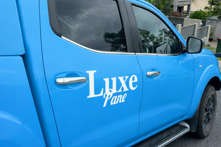 Blue vehicle with the words "Luxe Lane" written on the door.