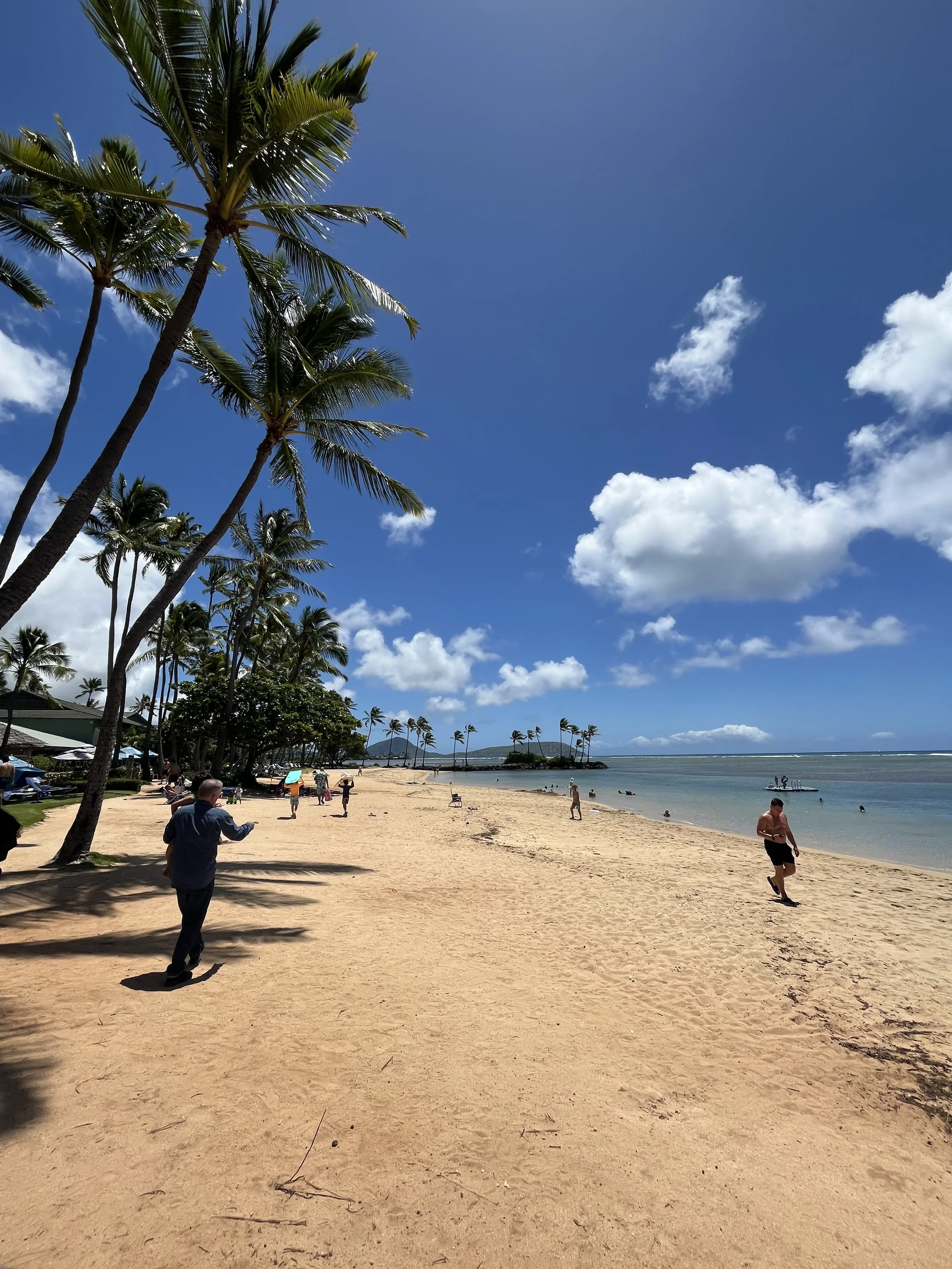exterior shot of the beach area of the Kahala Resort on a sunny day