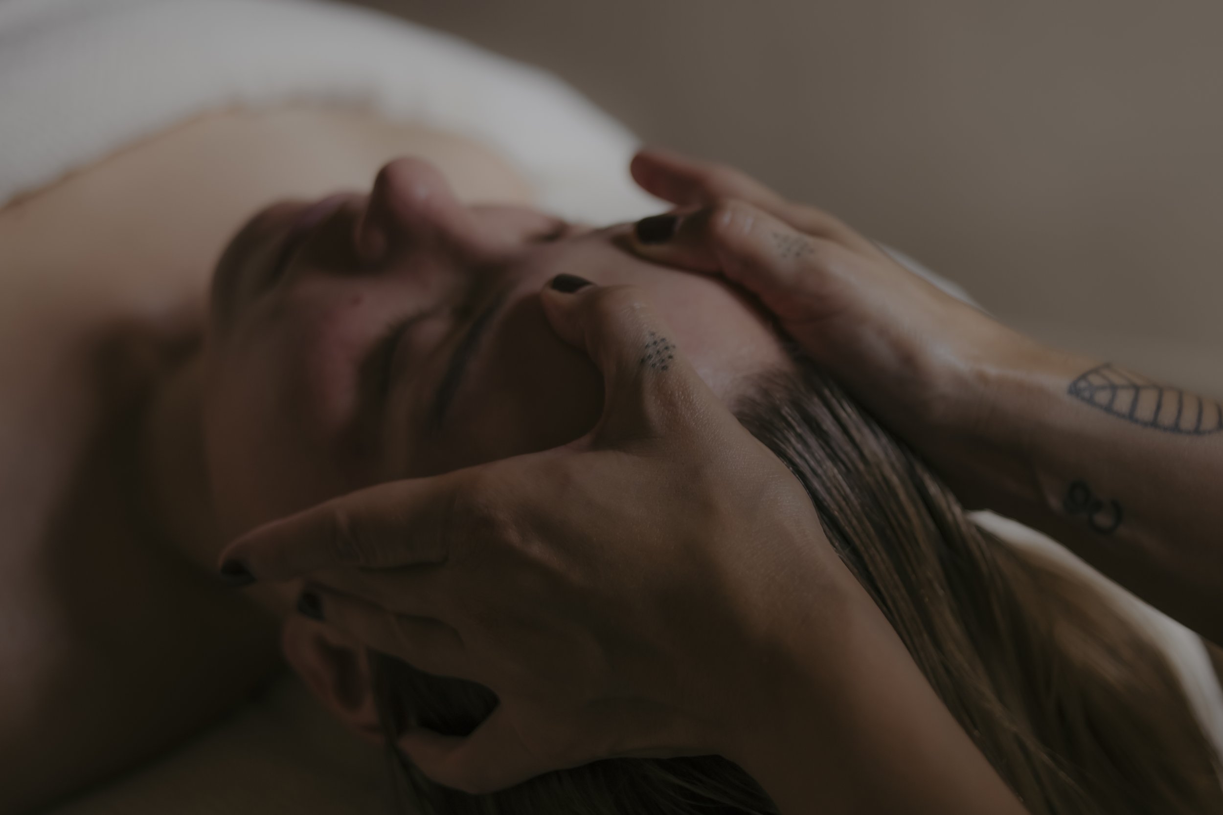 restorative facial treatment in brighton. Close up image of hands on face for lymphatic drainage work