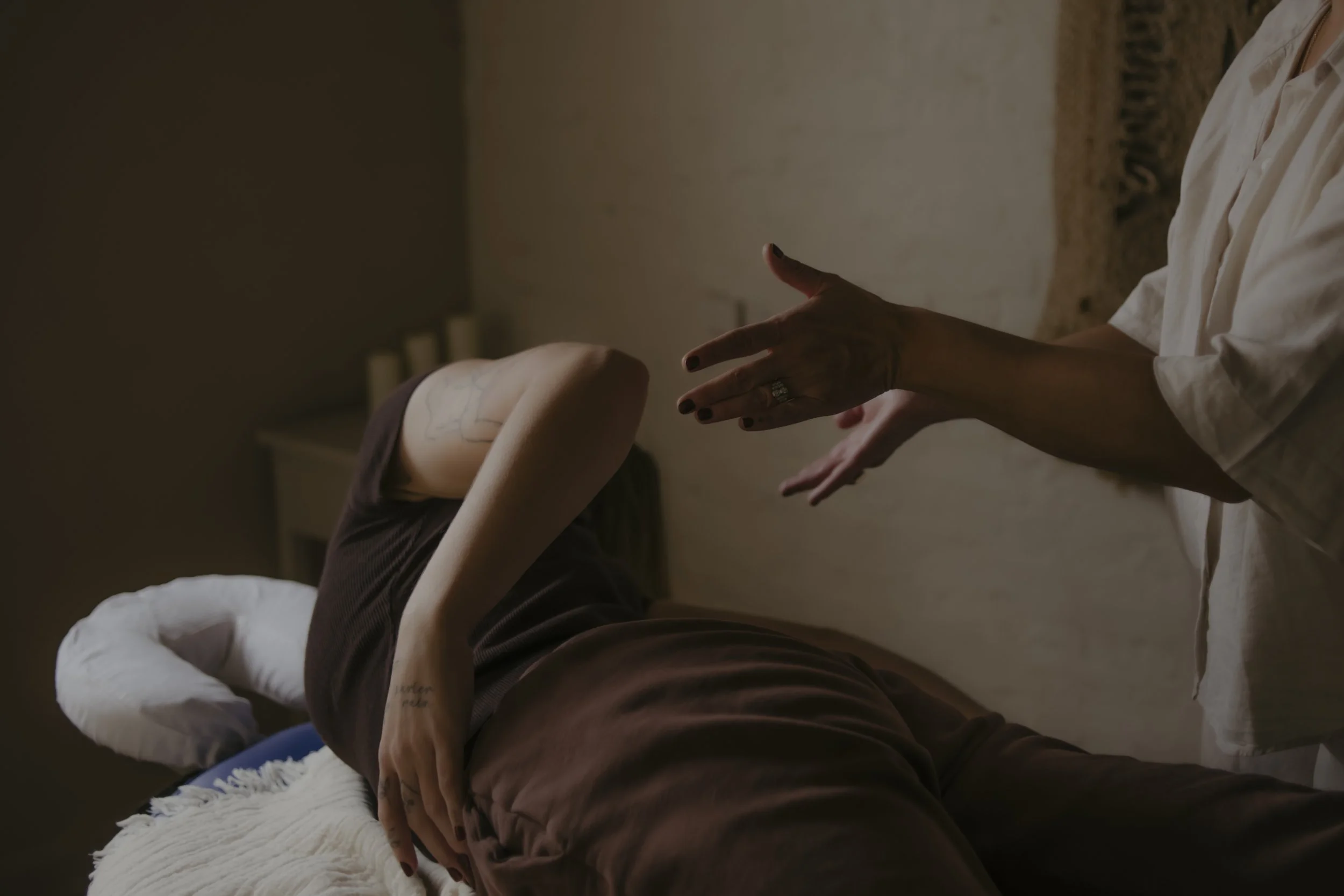 Person lying on a massage table during a nervous system treatment, somatics and energy work in Brighton