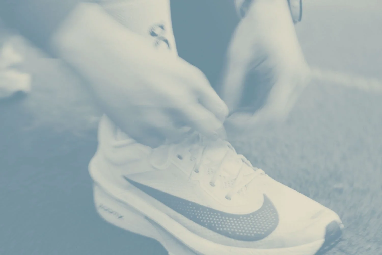 nahaufnahme von hannas sportschuh der marke nike. sie bindet grade die schleife.