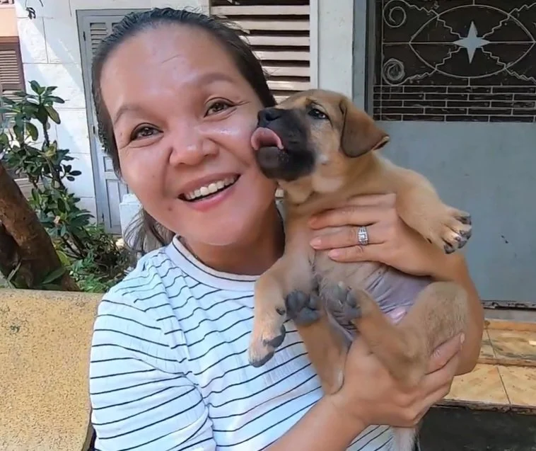 Kong Sovatana with puppy at pagoda siem reap