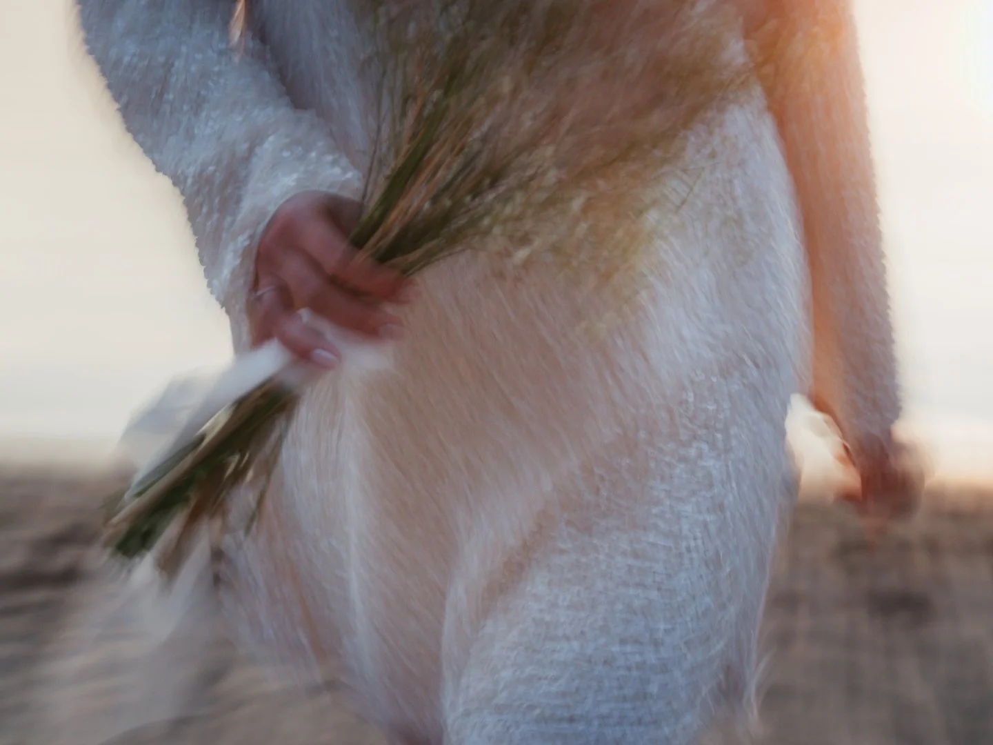 Bride holding a bouquet of flowers, nostalgic colors and blurry, retro photograph.