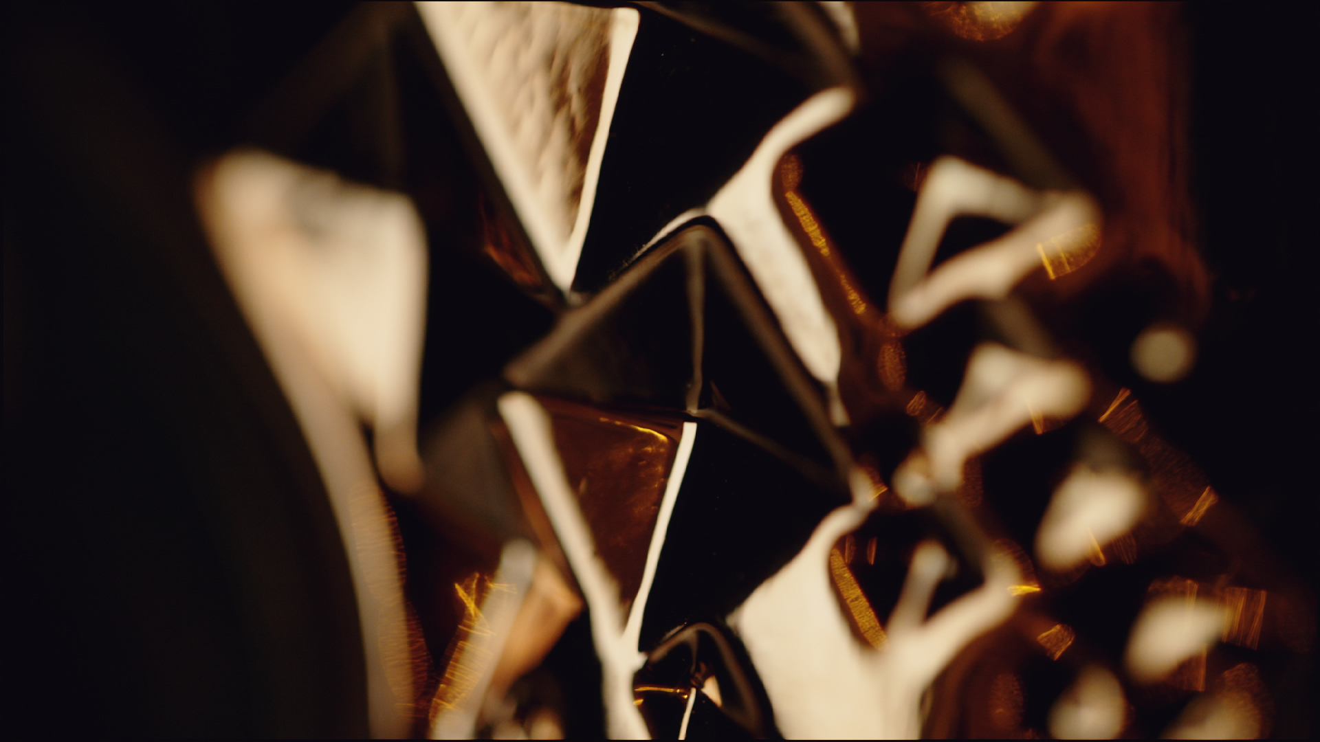 Close-up photo of a star-shaped metallic decorative object with intricate design, in warm lighting.