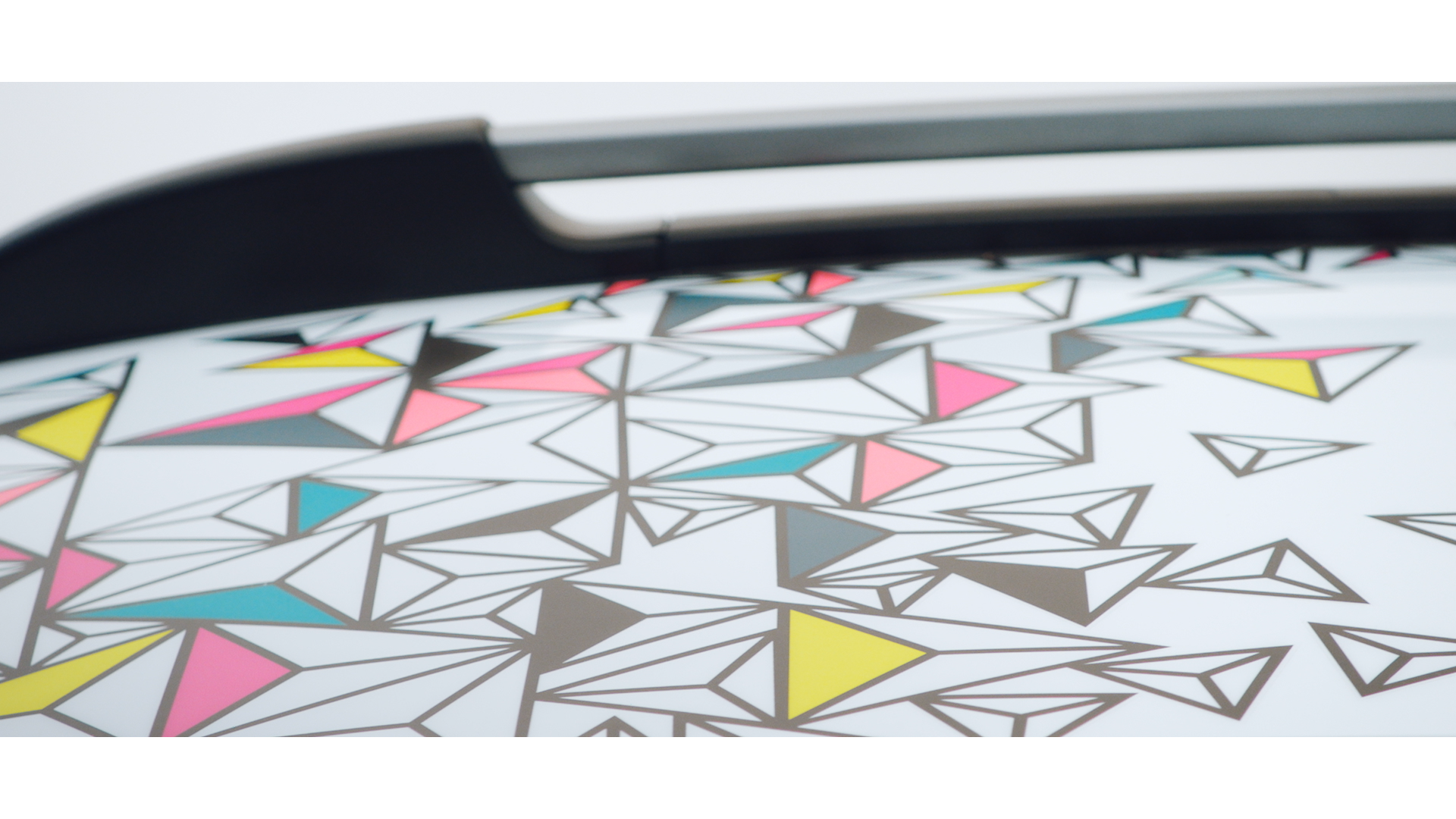 Close-up of a surface with a geometric pattern of colorful triangles and polygon outlines.