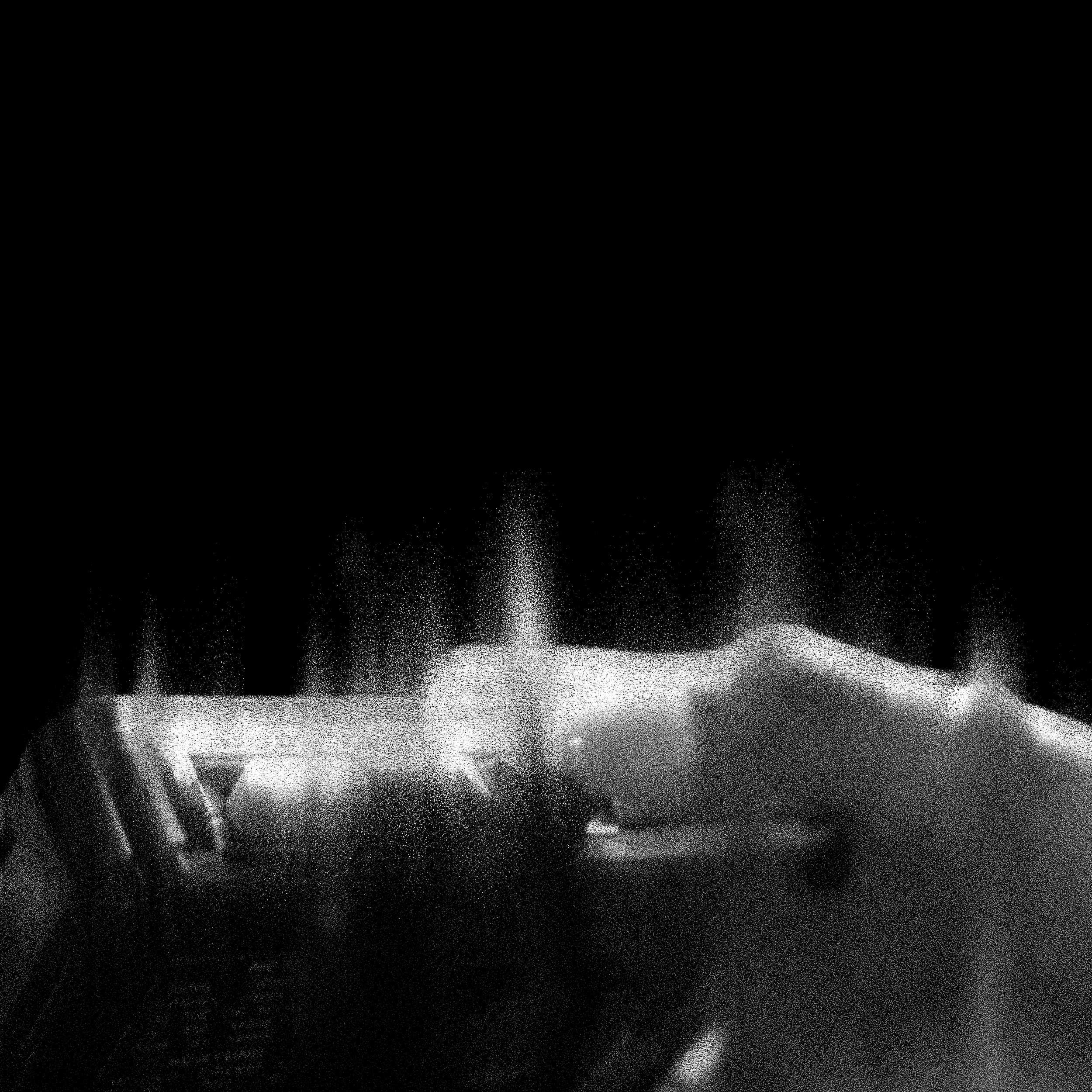 Close-up of a sparkler igniting, emitting bright sparks in the dark.