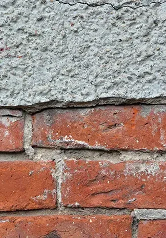 Bricks with cracked, crumbling mortar in need of pointing repair as done by Stork Roofing throughout North East Scotland