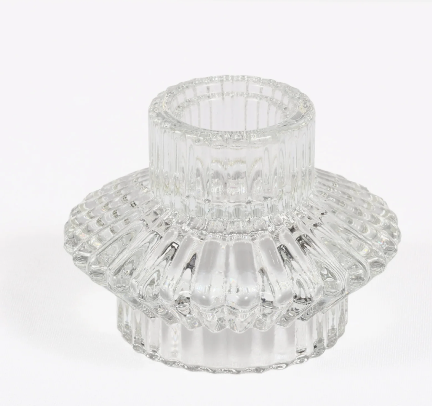 Clear glass candle holder with a ribbed, decorative design