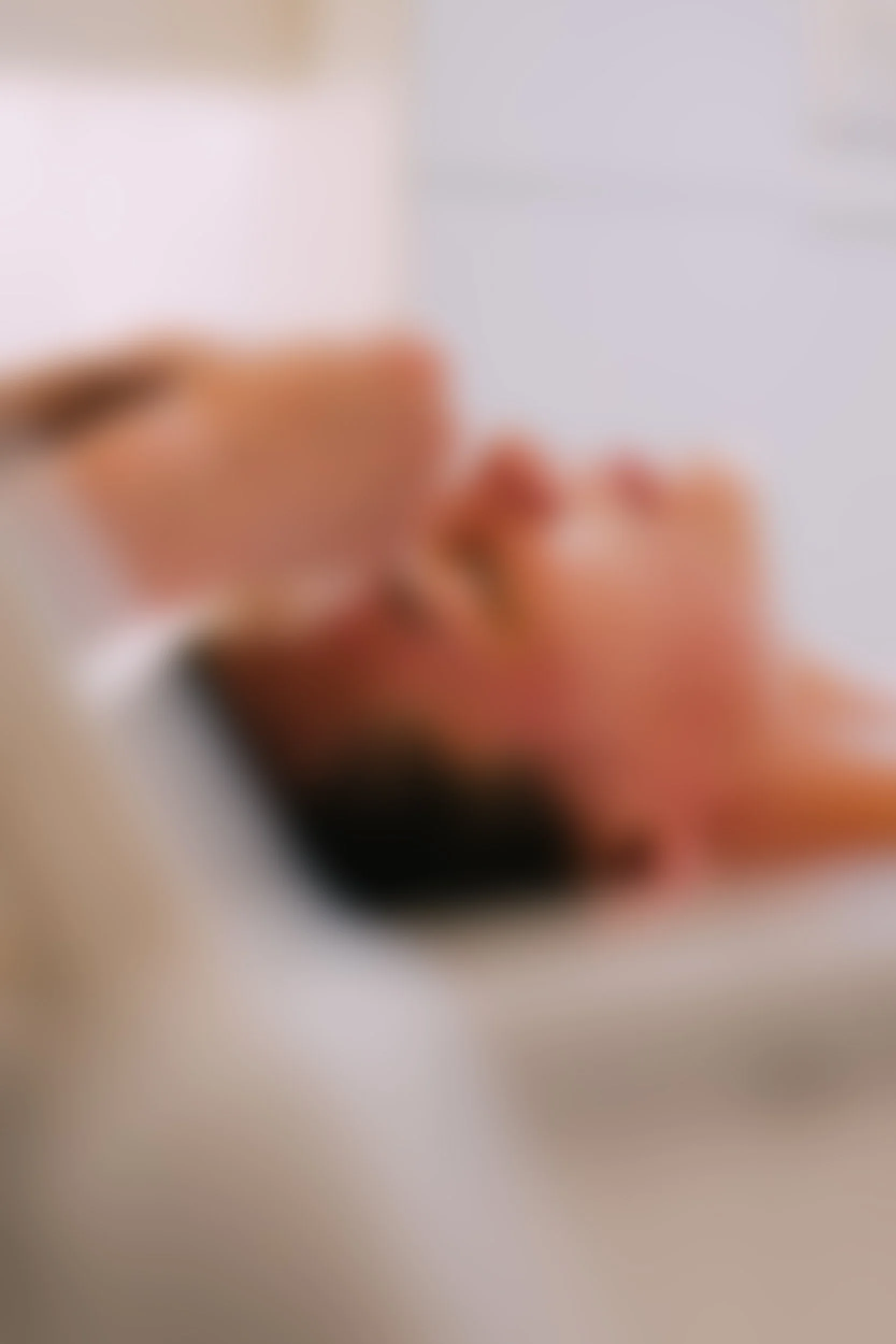 Blurred image of a person doing makeup with a brush.