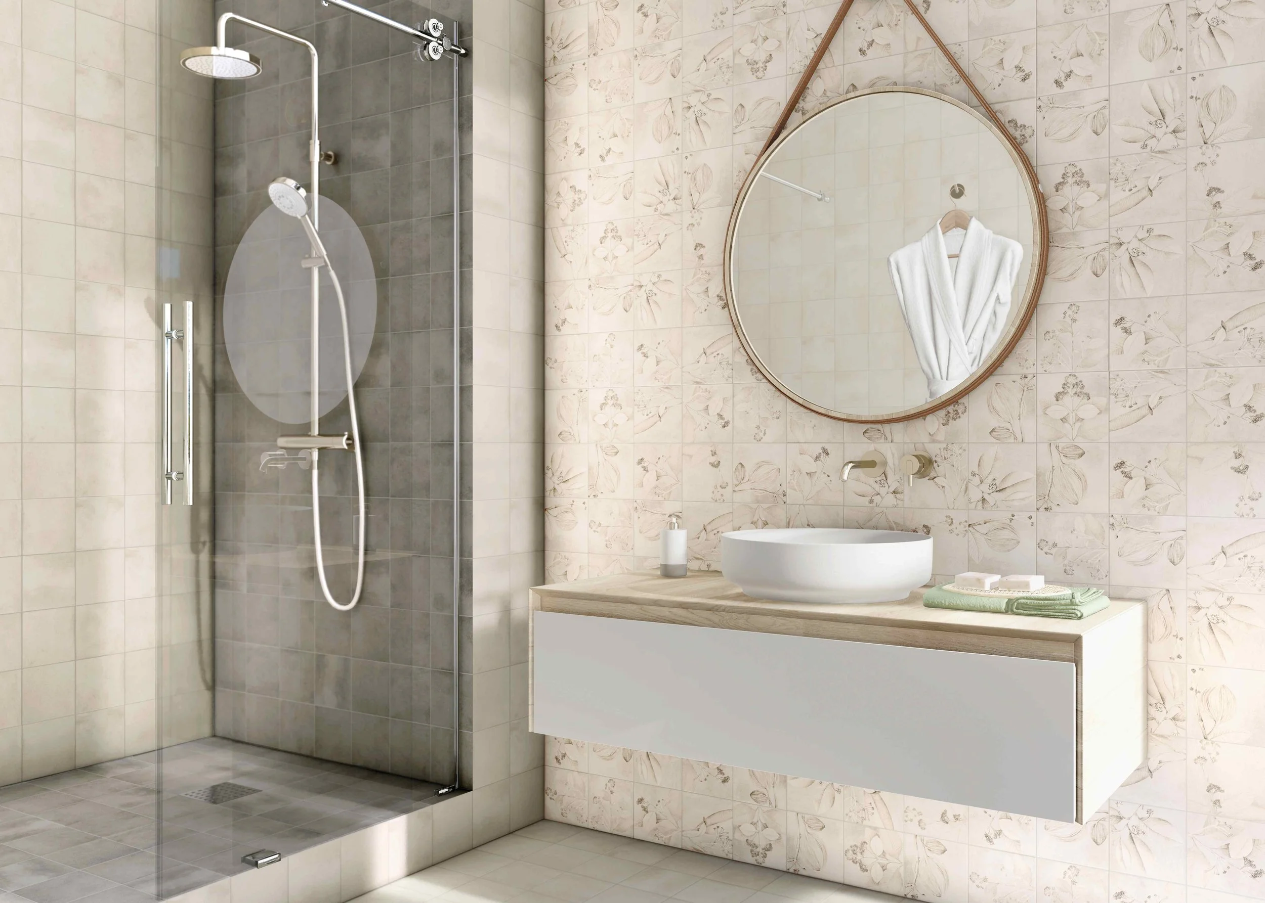 Modern bathroom with a shower stall, round mirror, white sink, towel, and floral wall tiles.