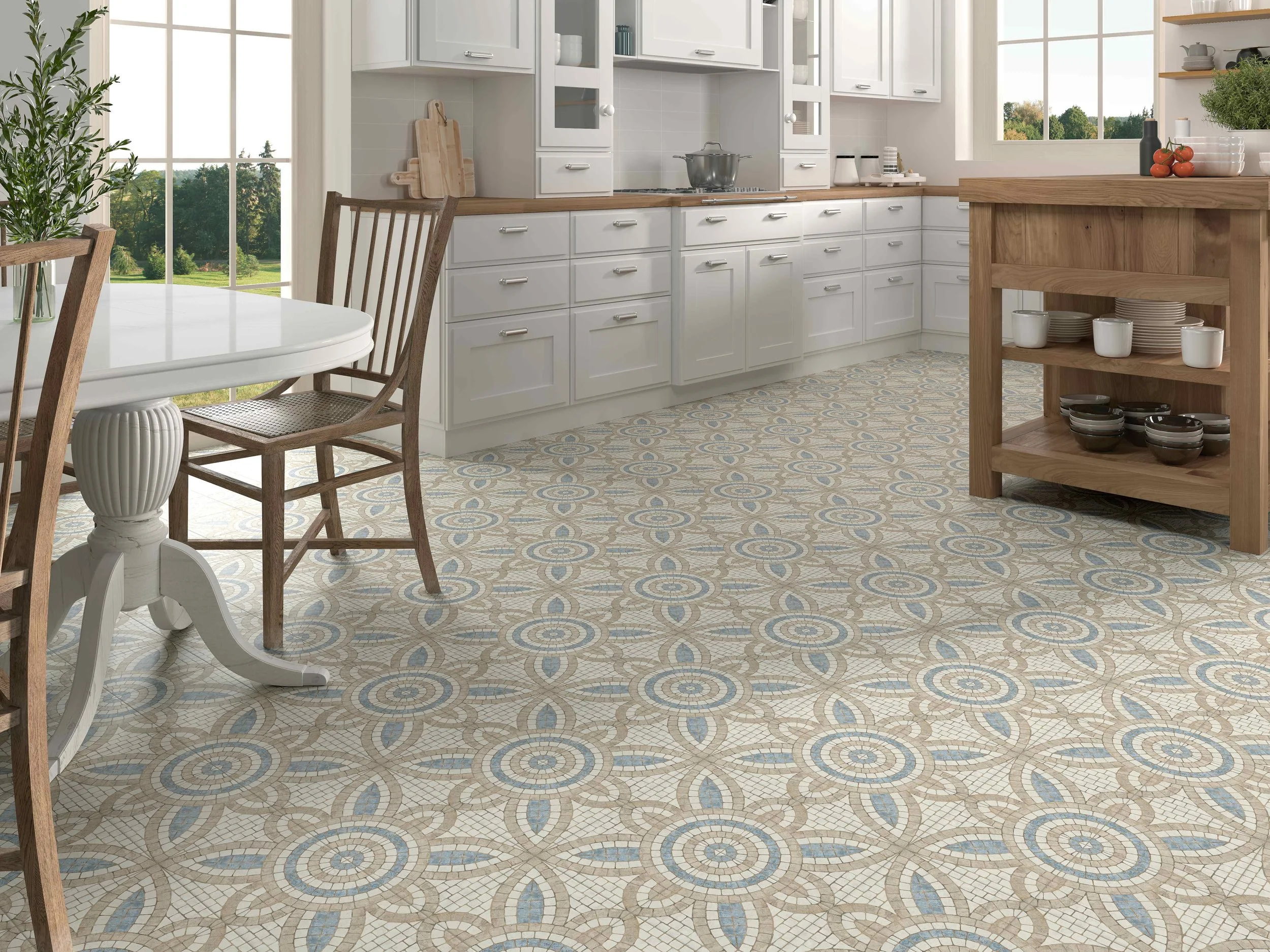 Bright kitchen with white cabinets, wooden accents, patterned tile floor, and large windows showing greenery outside.