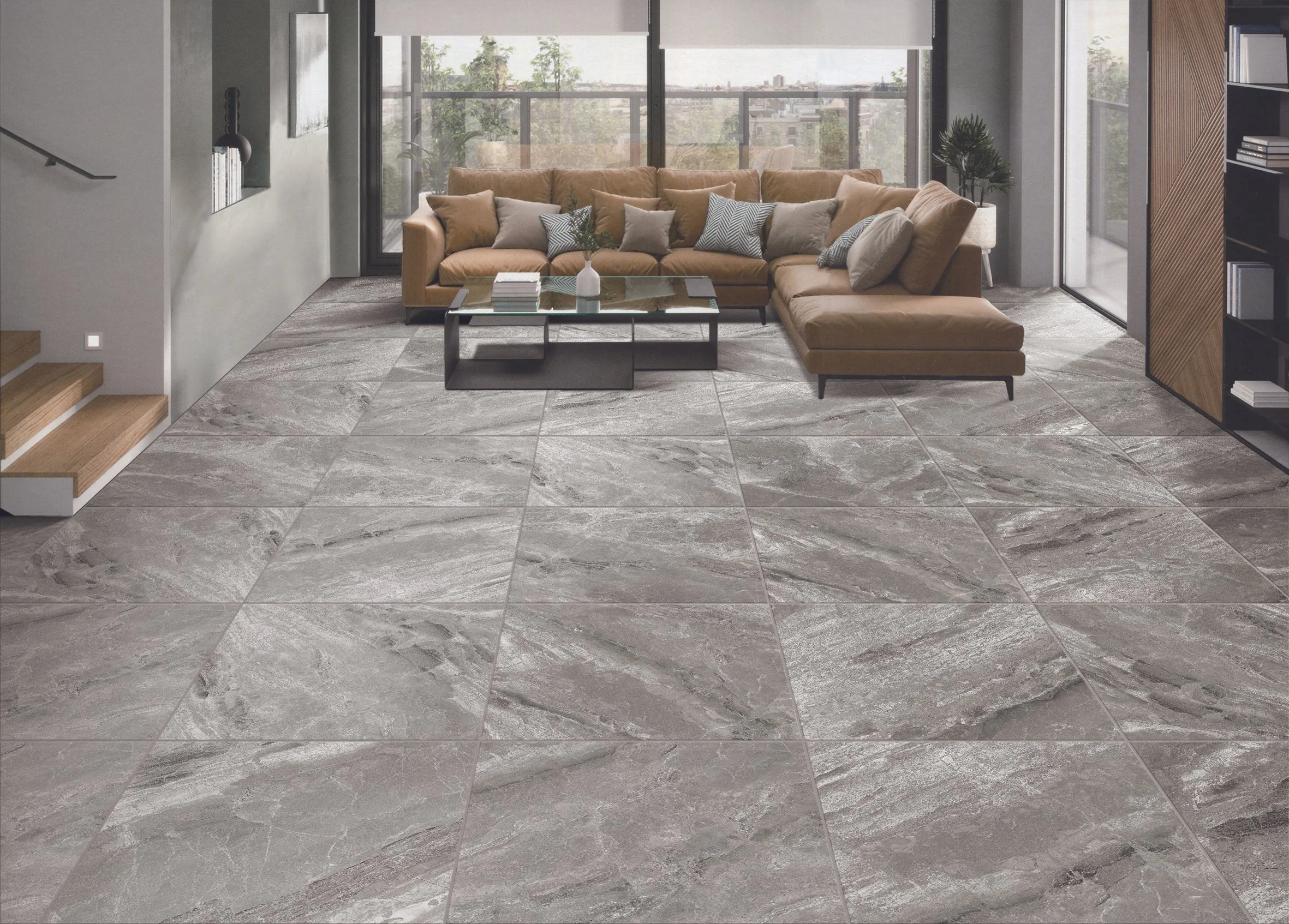 Modern living room with a large tan sectional sofa, throw pillows, glass coffee table, and large windows showing a city view.