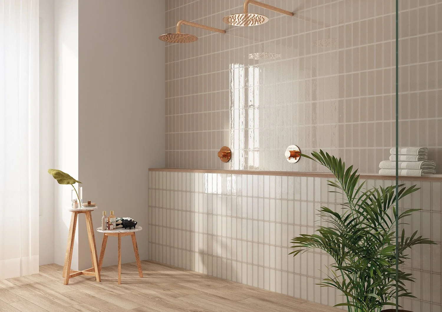 Modern shower area with two gold showerheads, built-in shelf with white towels, wooden floor, green plant, small table with toiletries, and sheer curtains.