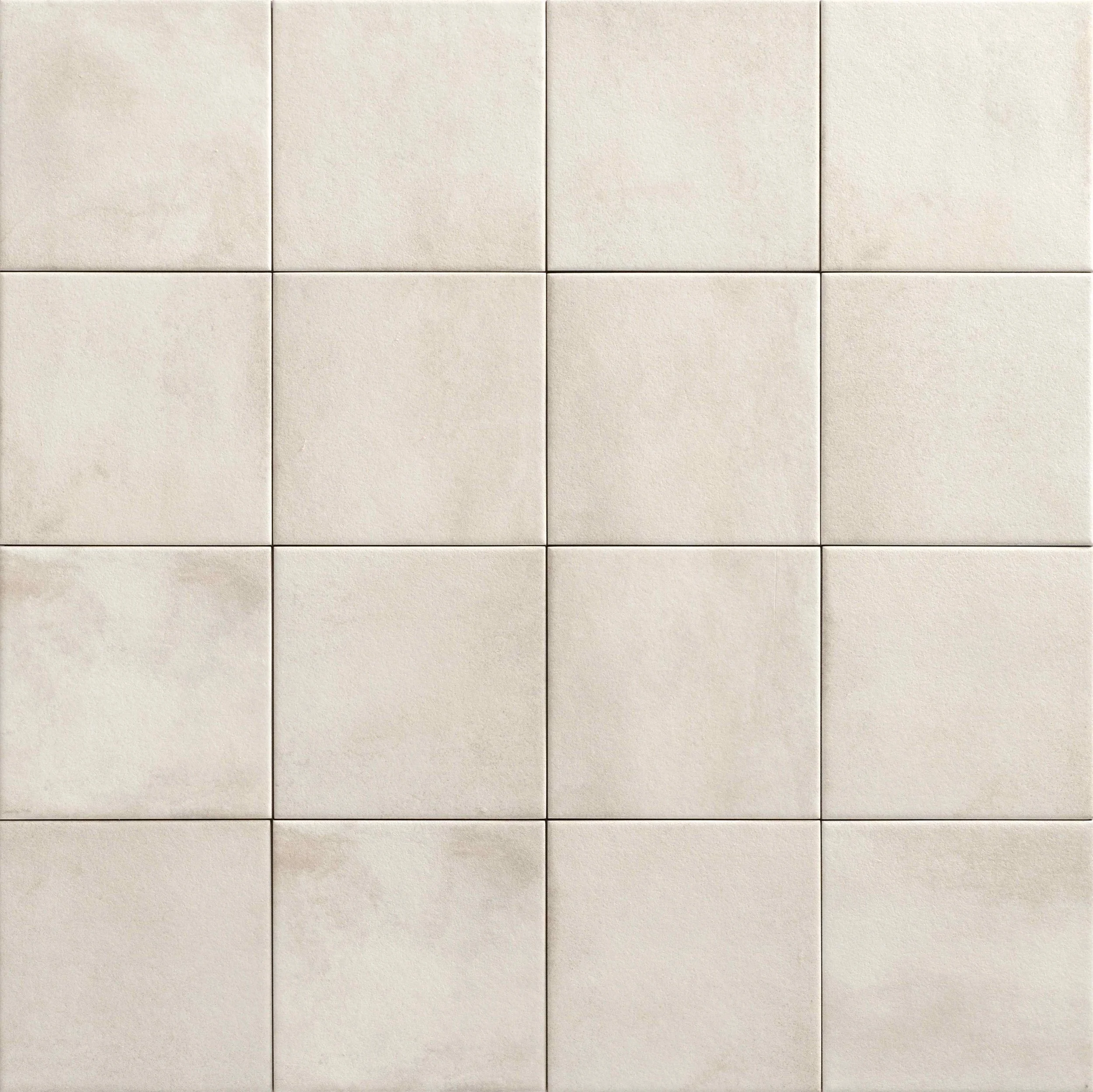 A close-up view of a grid of beige ceramic tiles with slightly textured surfaces.