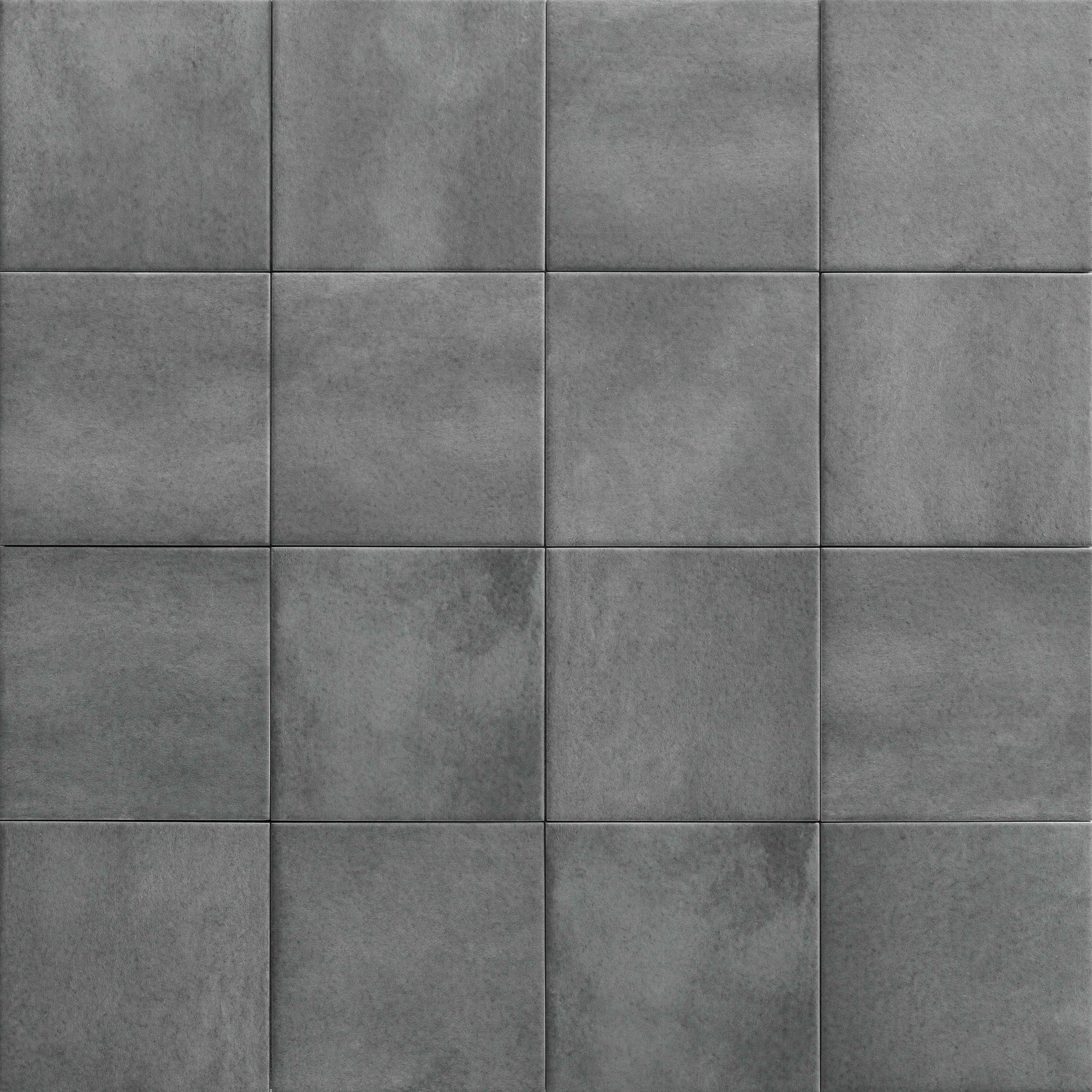 A close-up view of 12 gray concrete tiles arranged in a 4x3 grid, showing textured surfaces with subtle variations in shading and small water stains.