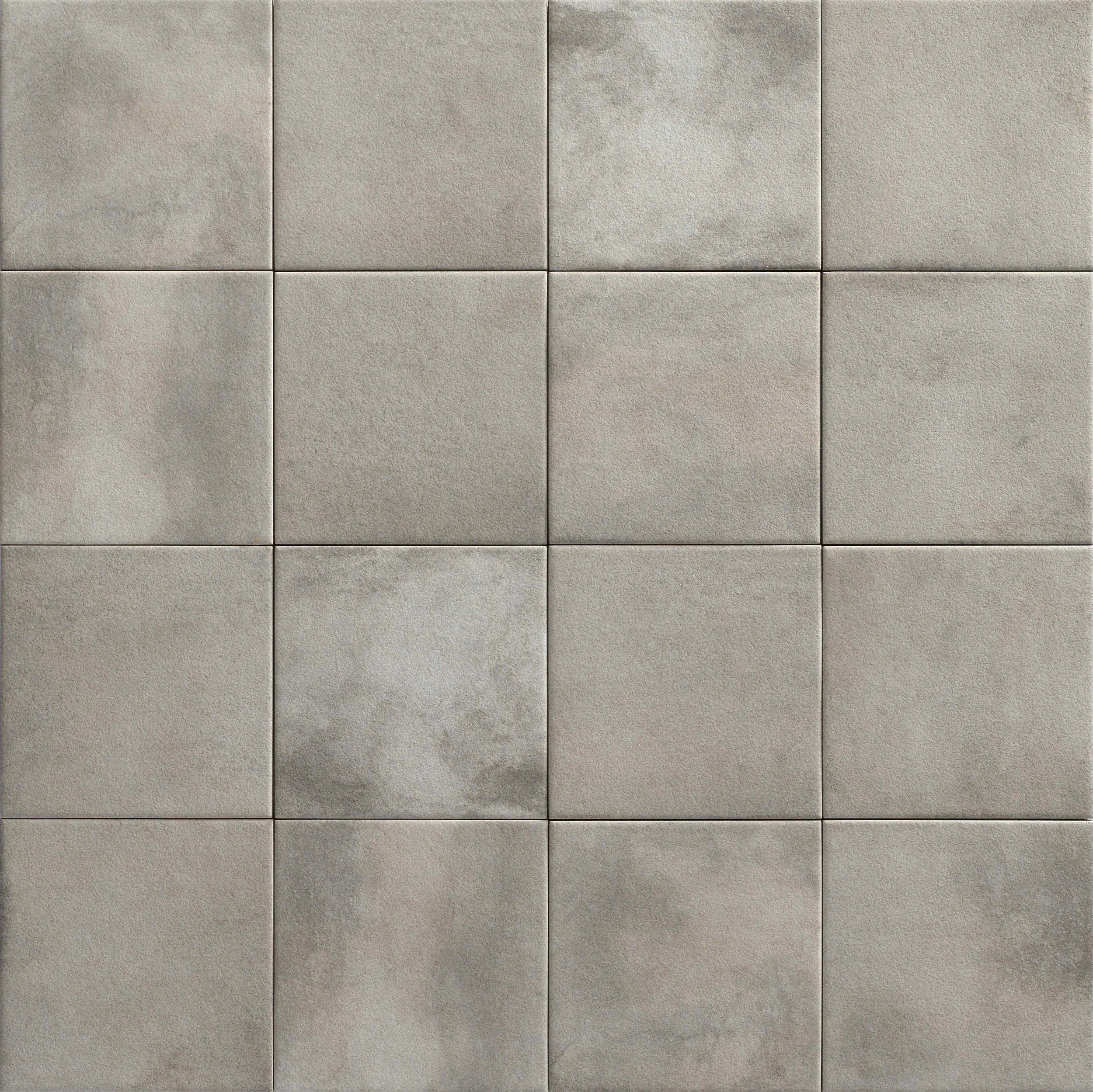 A grid of 16 square concrete tiles with varied shades and textures.