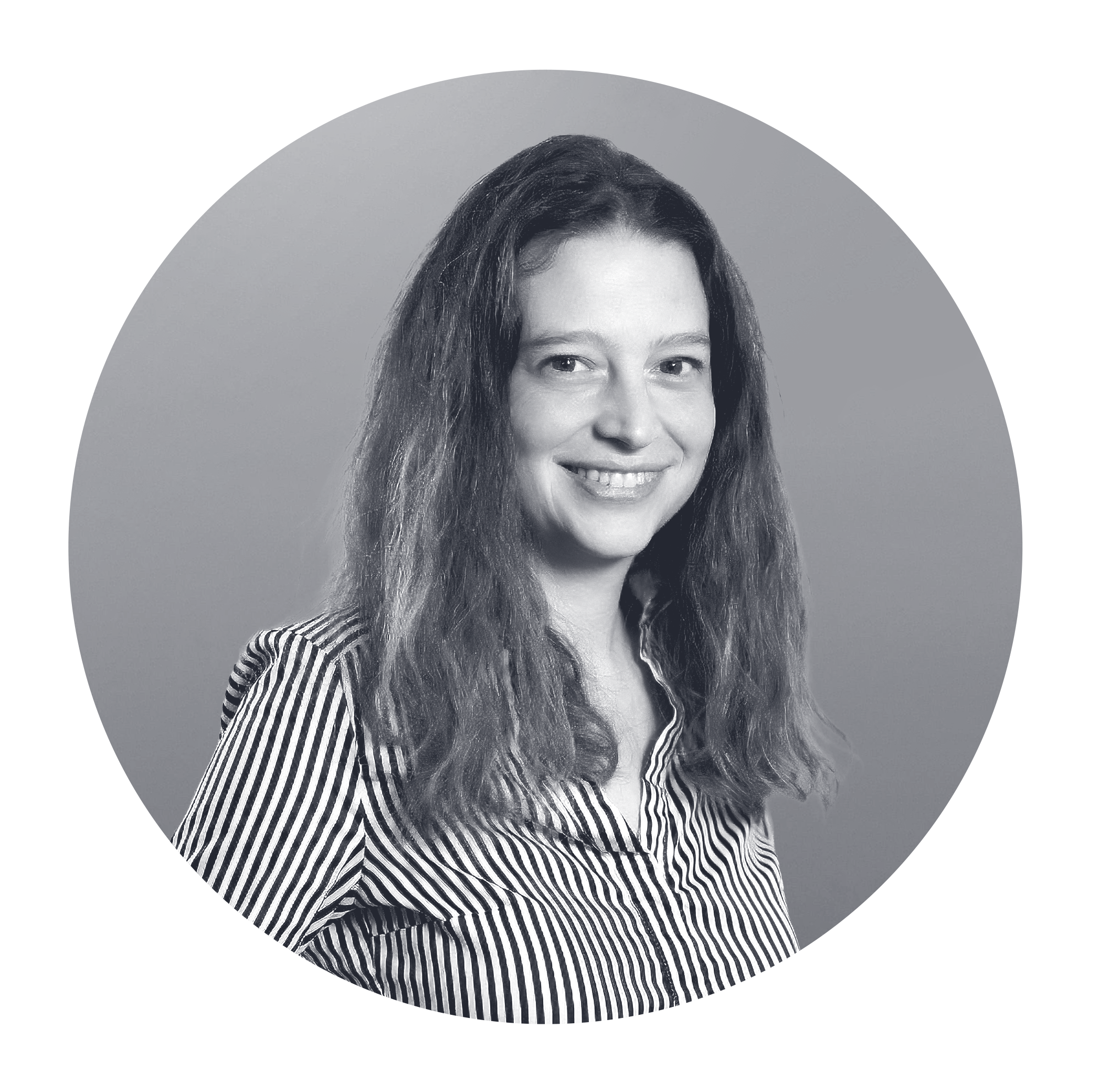 Black and white portrait of a woman with shoulder-length wavy hair, wearing a striped shirt, smiling, against a plain background.