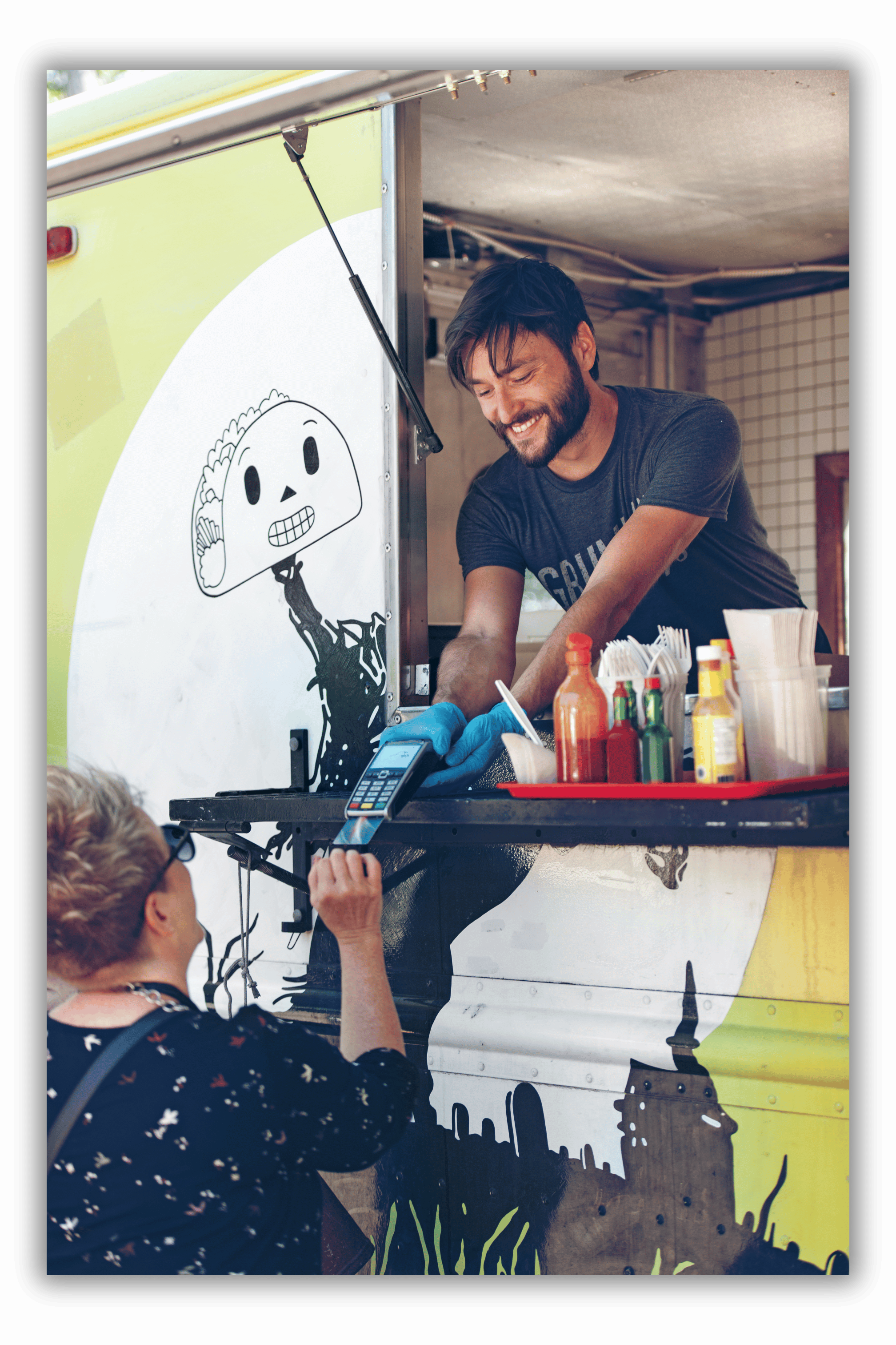 Food truck worker taking payment from customer