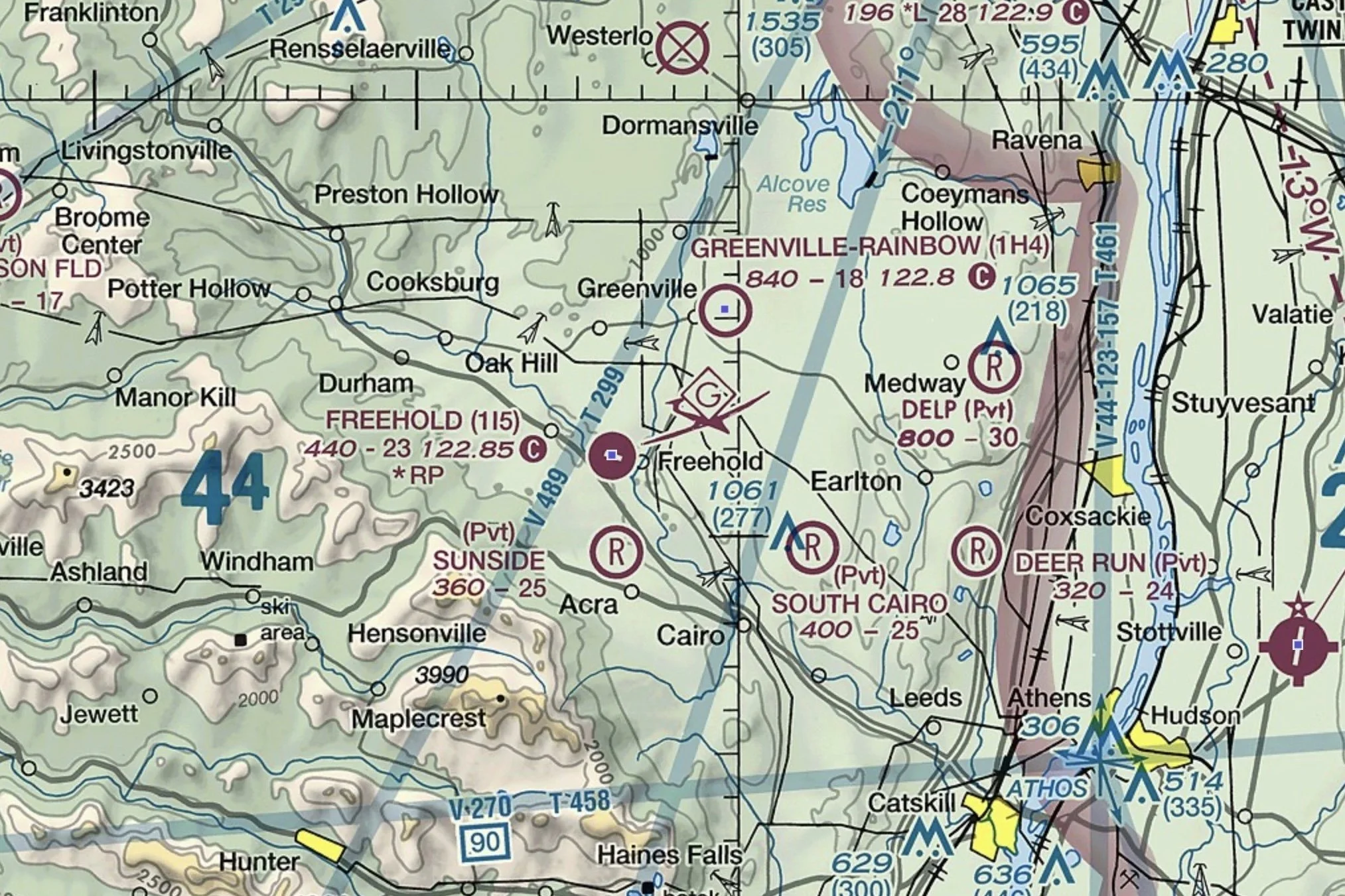 Section of a US aeronautical sectional chart showing towns, lakes, elevation contours, and several weather and navigation symbols.