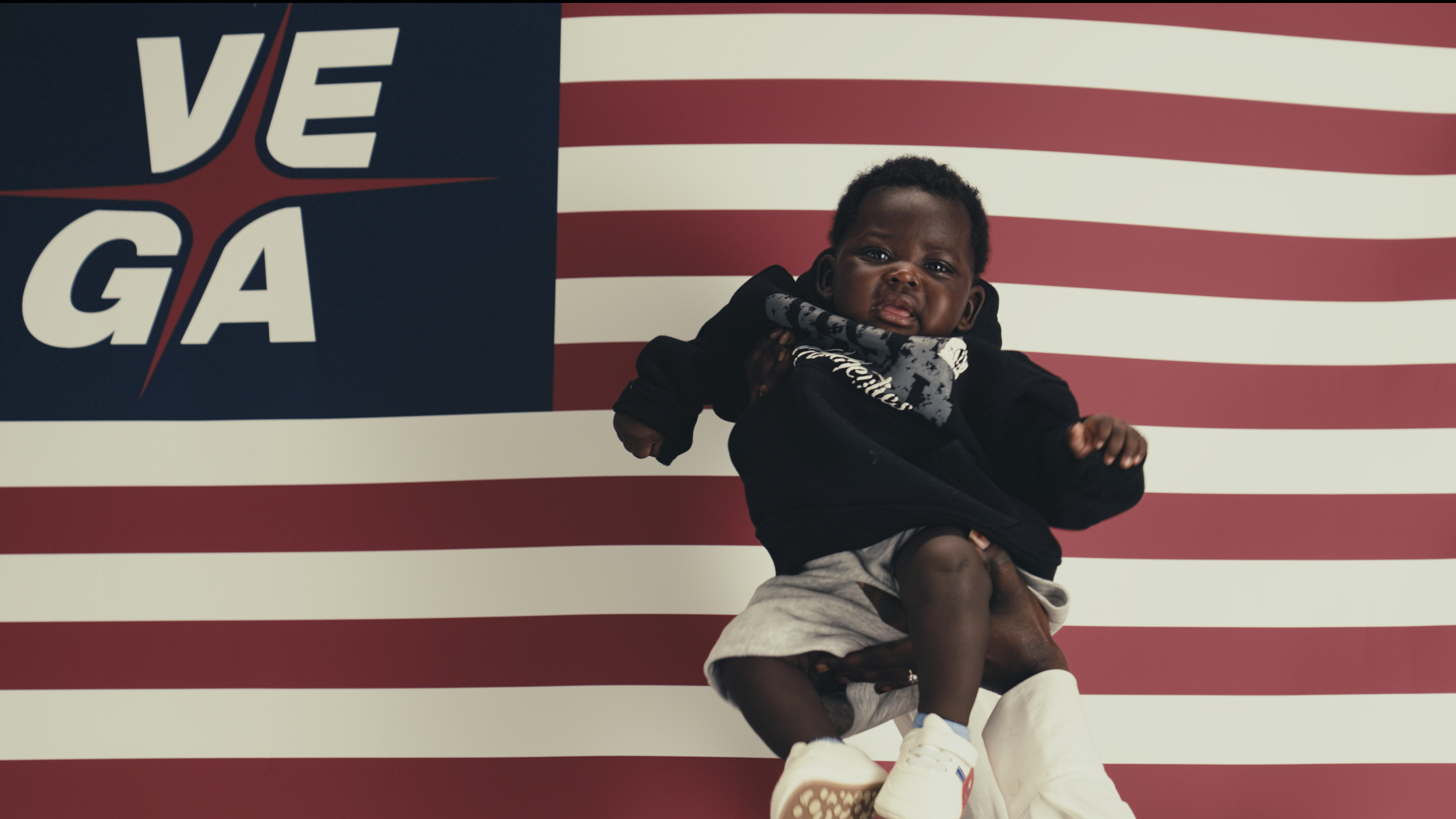 An image of a baby in front of a USA themed flag