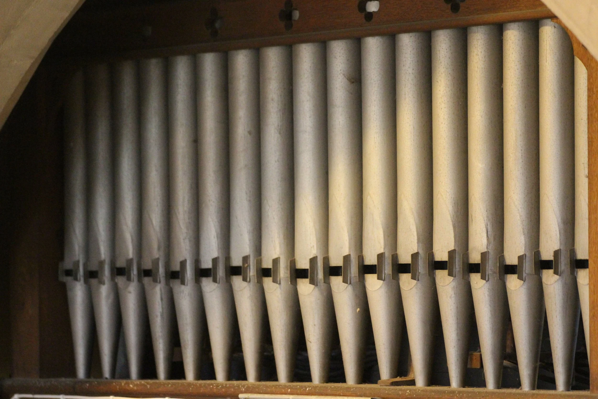 Close-up view of the historic organ pipes at St Andrew's Church, Leighterton, Gloucestershire.