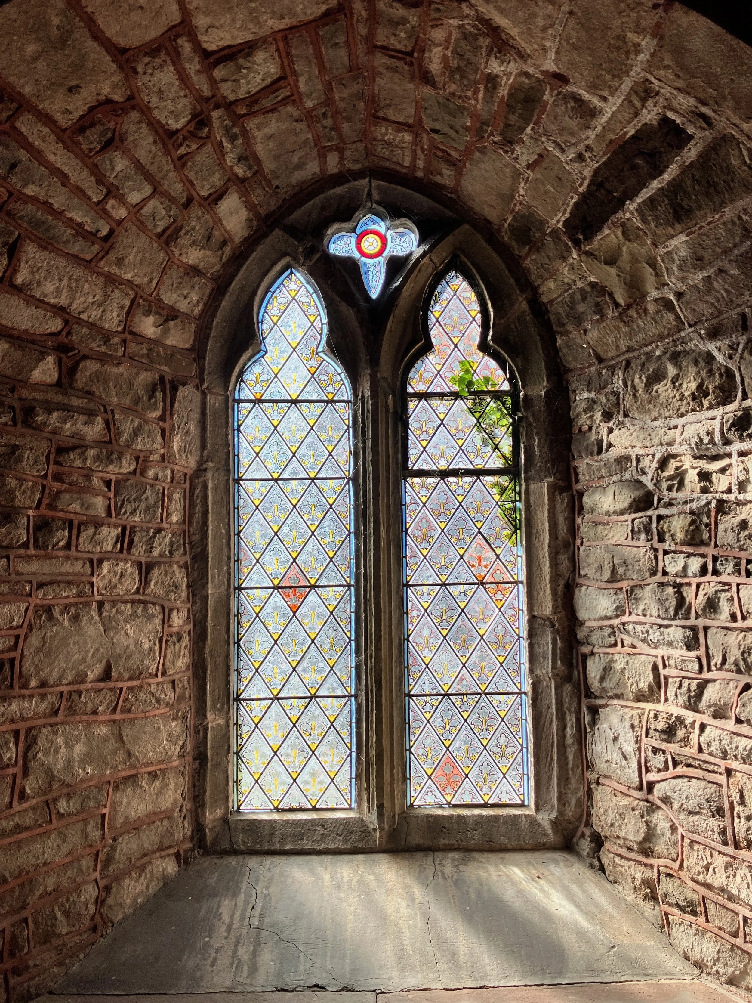 An ancient church window at St Cadoc Church Raglan in Monmouthshire UK