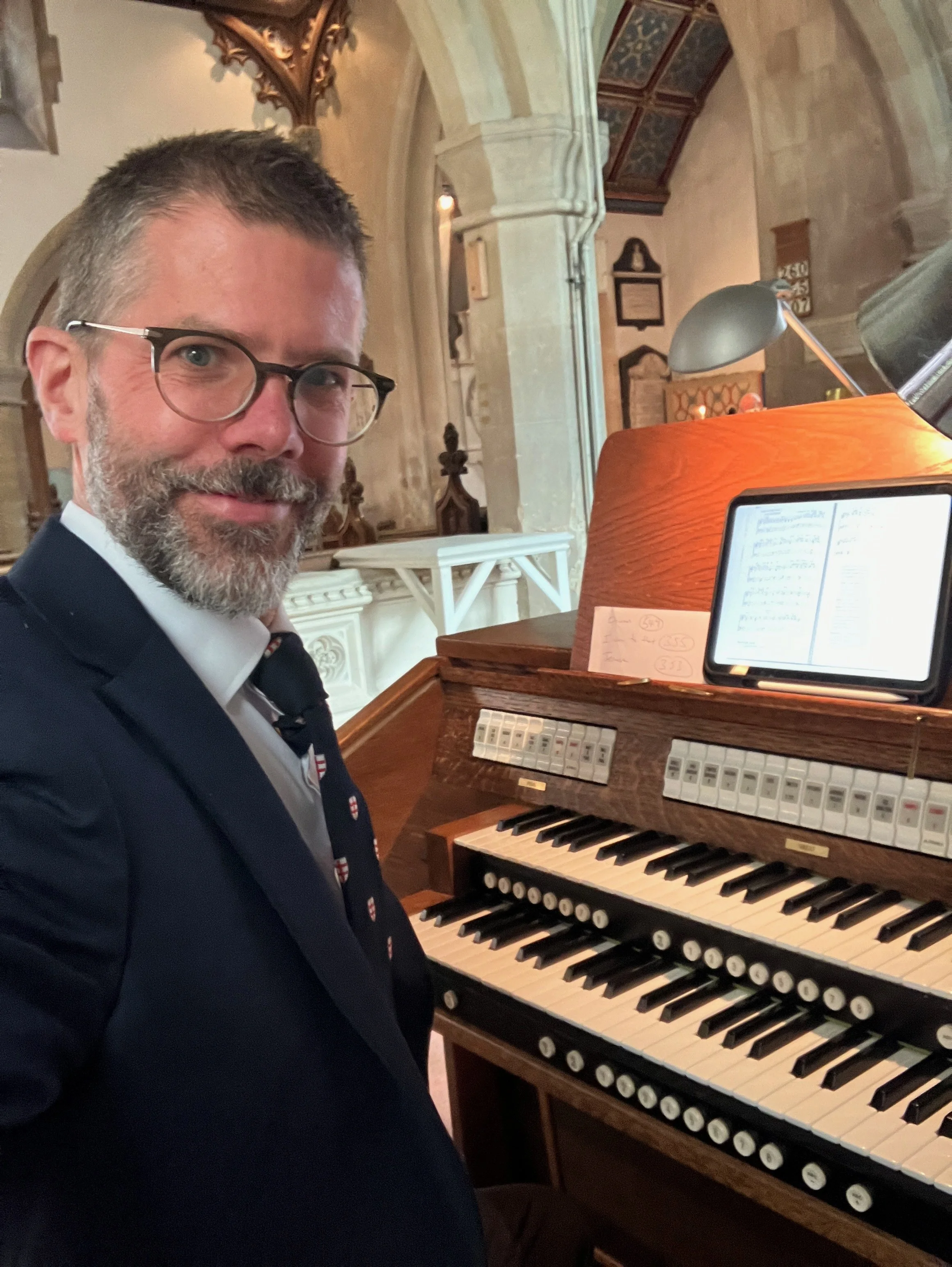 Benjamin Humphries playing the pipe organ at a wedding ceremony in St Michael and All Angels Church, Eastington, near Stroud, Gloucestershire