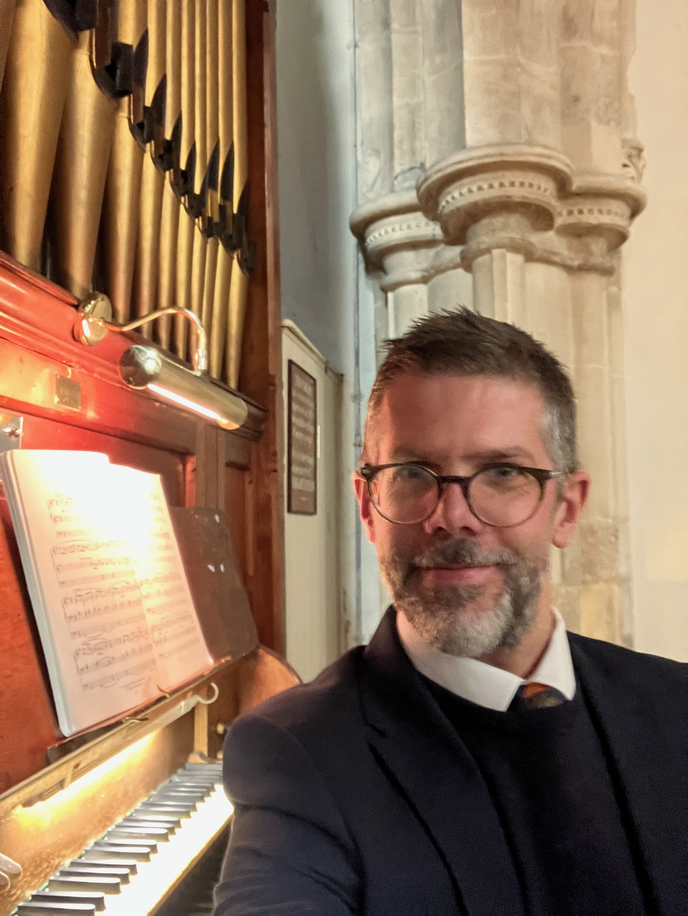 Benjamin Humphries at the pipe organ console in a Gloucestershire church