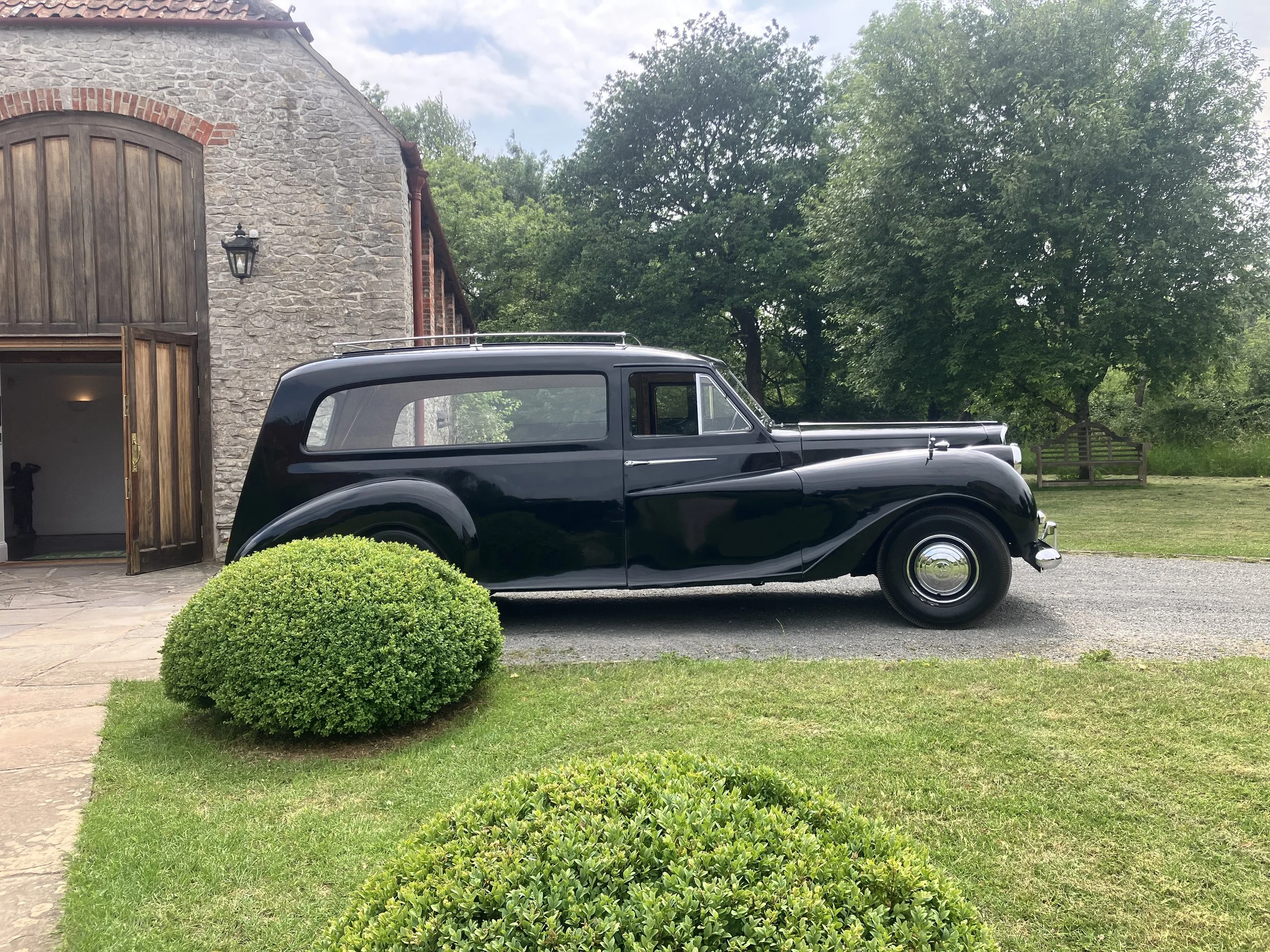 A historic hearse parked outside as Bristol organist Ben Humphries rehearses to play hymns at a funeral service at the Bristol Memorial Woodlands venue in South Gloucestershire