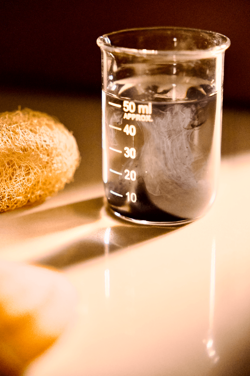 An image of organic SMP pigment disperses in water in sunlight, mimicking the SMP result that looks natural.