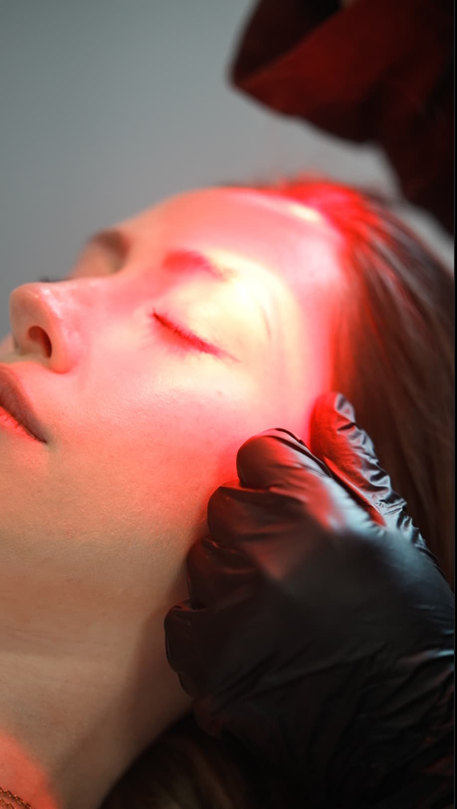 A picture of a client under Red Light Therapy ritual, in a calming environment.