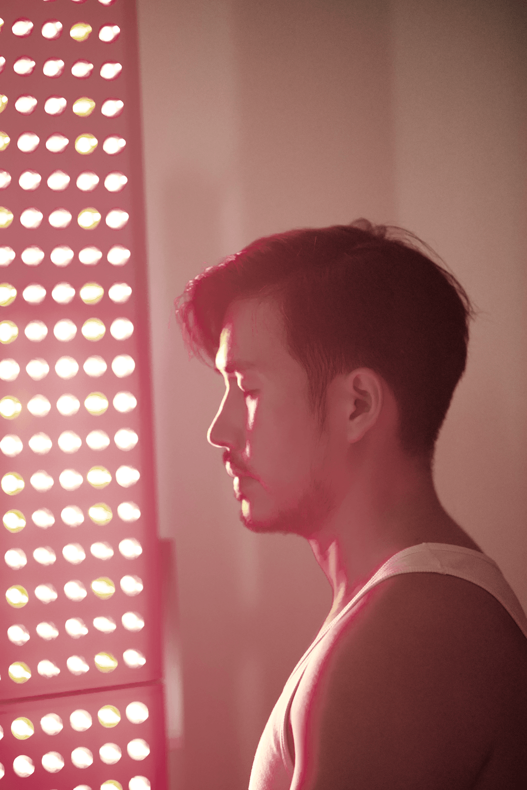 A picture of Athera Tay in Red Light Therapy ritual, in a calming environment.