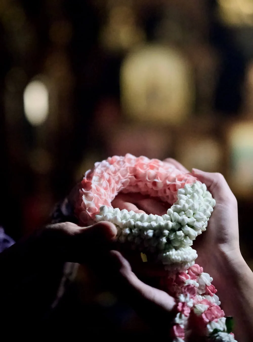 Thai flower garland is passing on from Athera Tay to a client as a gesture of grace initiative to restore their appearance.