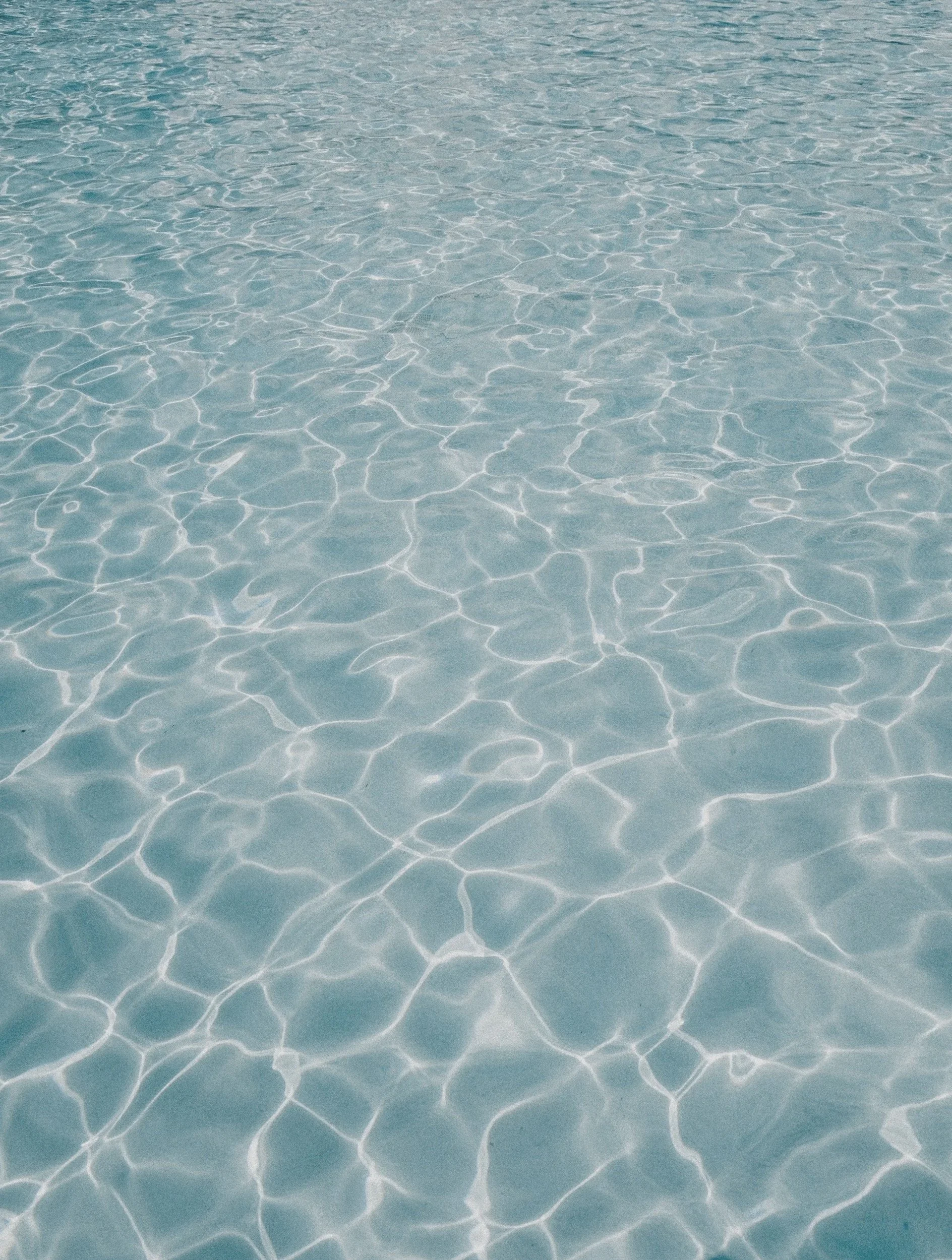 Clear water in a pool with visible ripples and light reflections.
