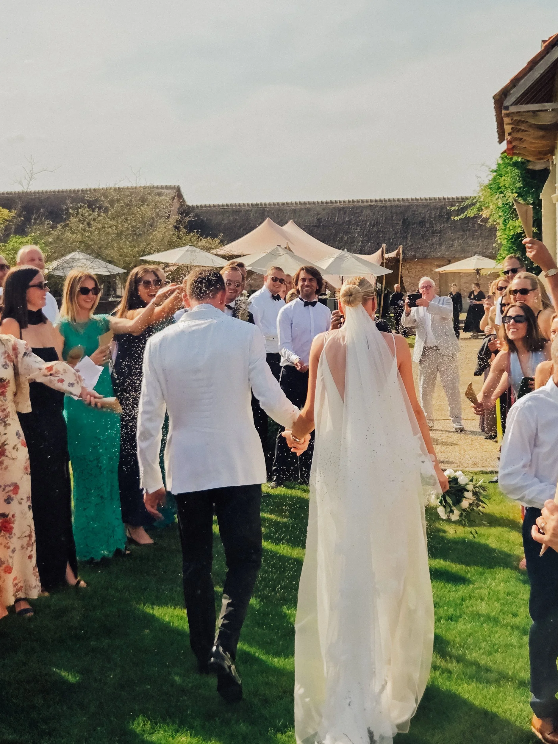 Cinematic picture of high-end wedding couple walking down the isle, beautiful dress and lighting.