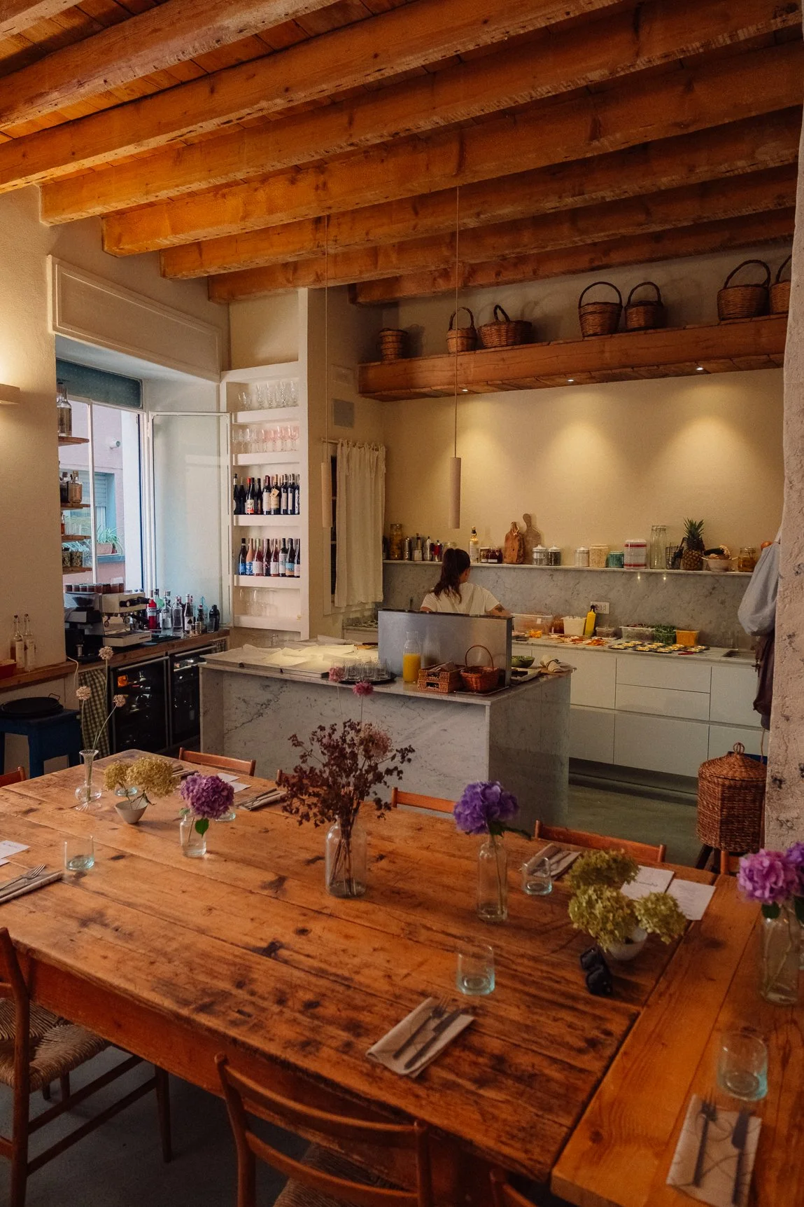 Rustic modern kitchen interior at Dispensa 63 in Bellagio, featuring warm wood tones and soft natural light.