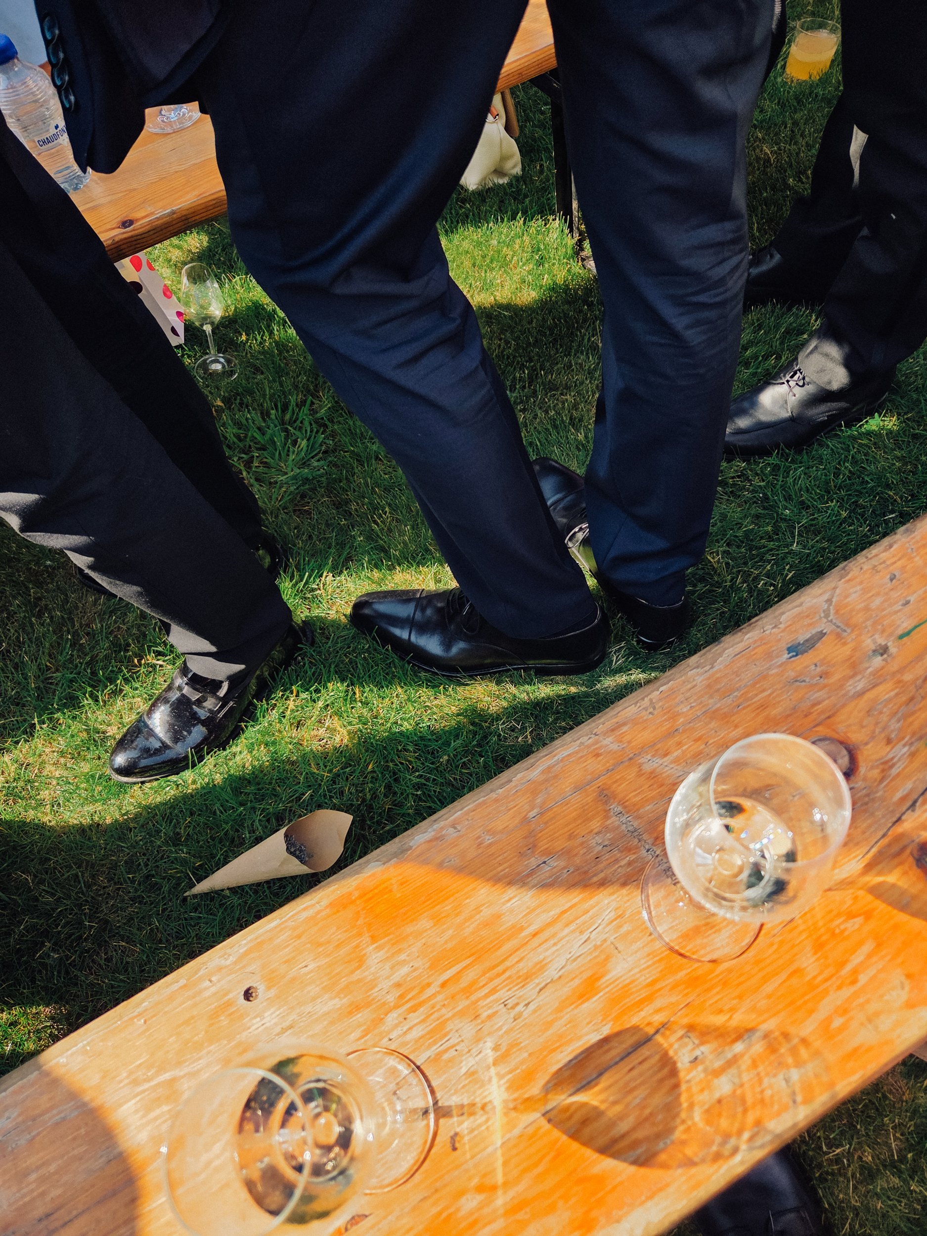 Detail shot of men's tuxedo pants and shoes during a black tie wedding, cinematic storytelling wedding photography in Belgium