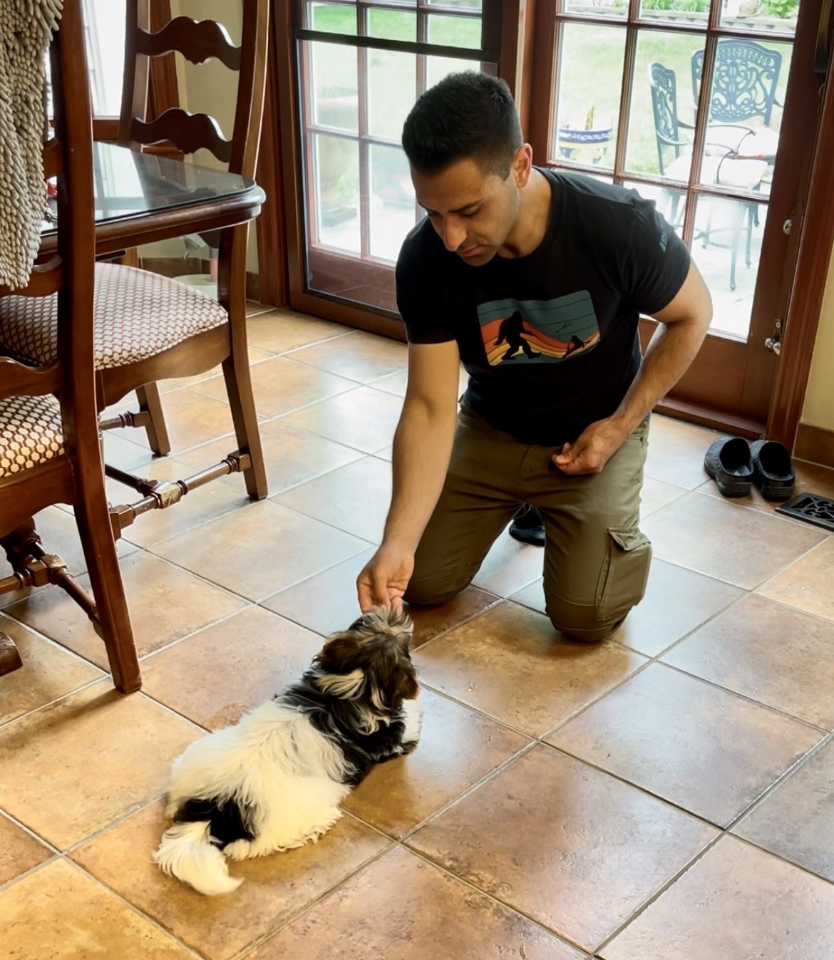 Anthony teaching puppy to lay down