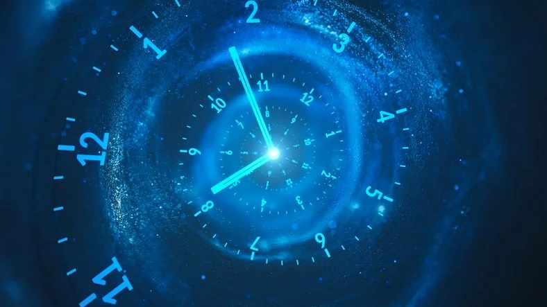Digital clock display with a spiral effect, showing the time as approximately 10:58, with glowing blue and white colors.