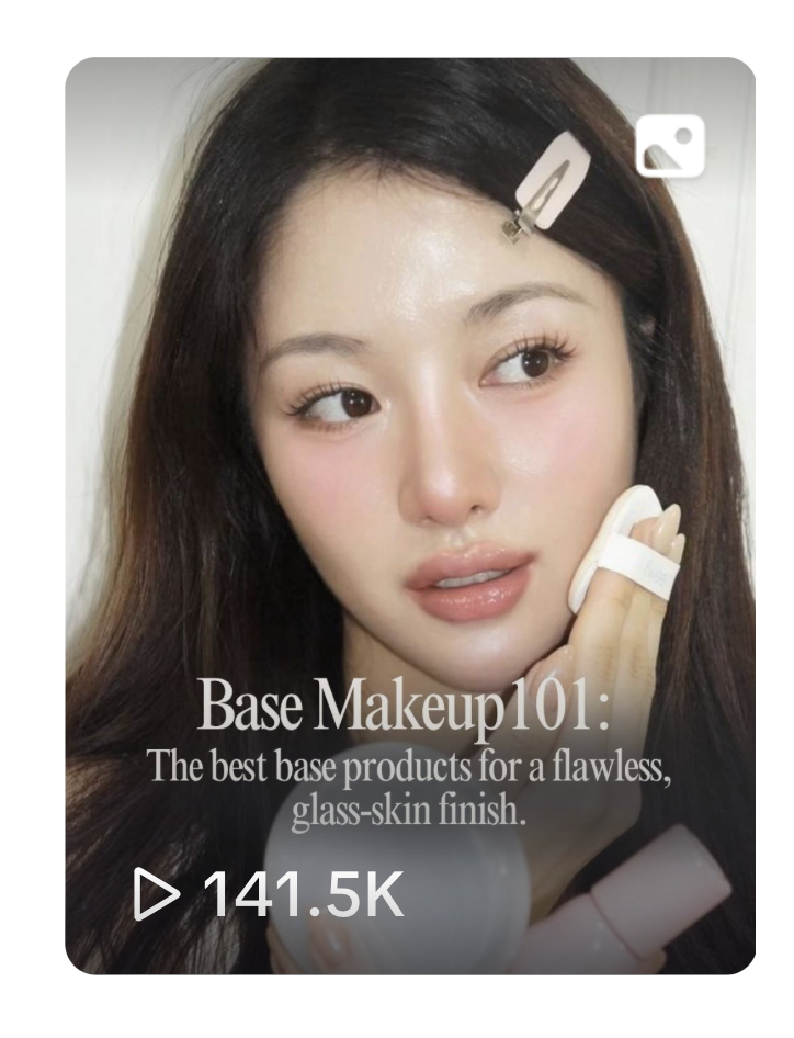 A woman with long dark hair applying makeup, holding a makeup sponge, with a hair clip in her hair. The image features text about beginner makeup tips and a view count of over 141,500.