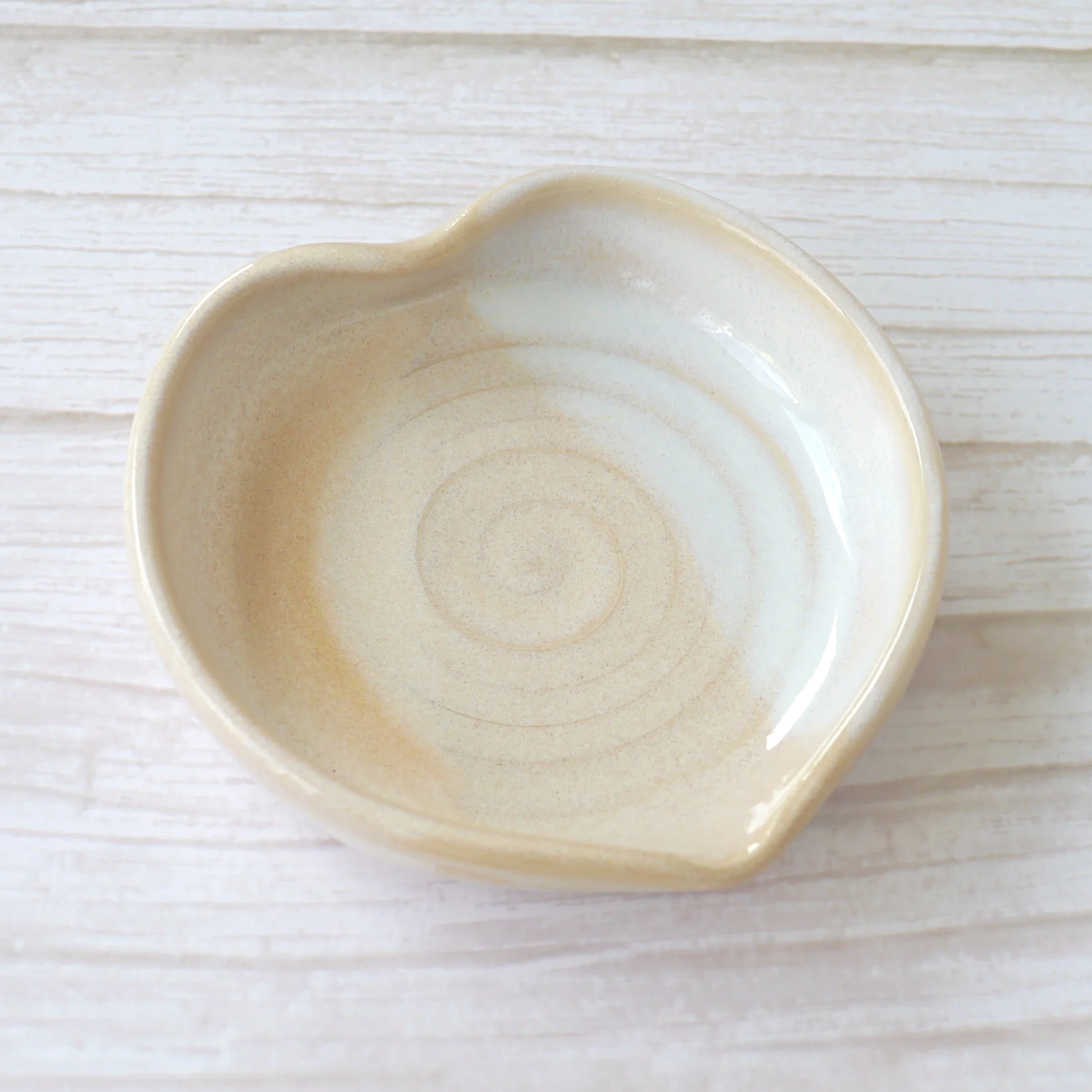 Heart shaped stoneware ring dish. Each dish is lovingly crafted on my potter’s wheel from premium white stoneware clay and finished with a beautiful blend of beige and white glazes.